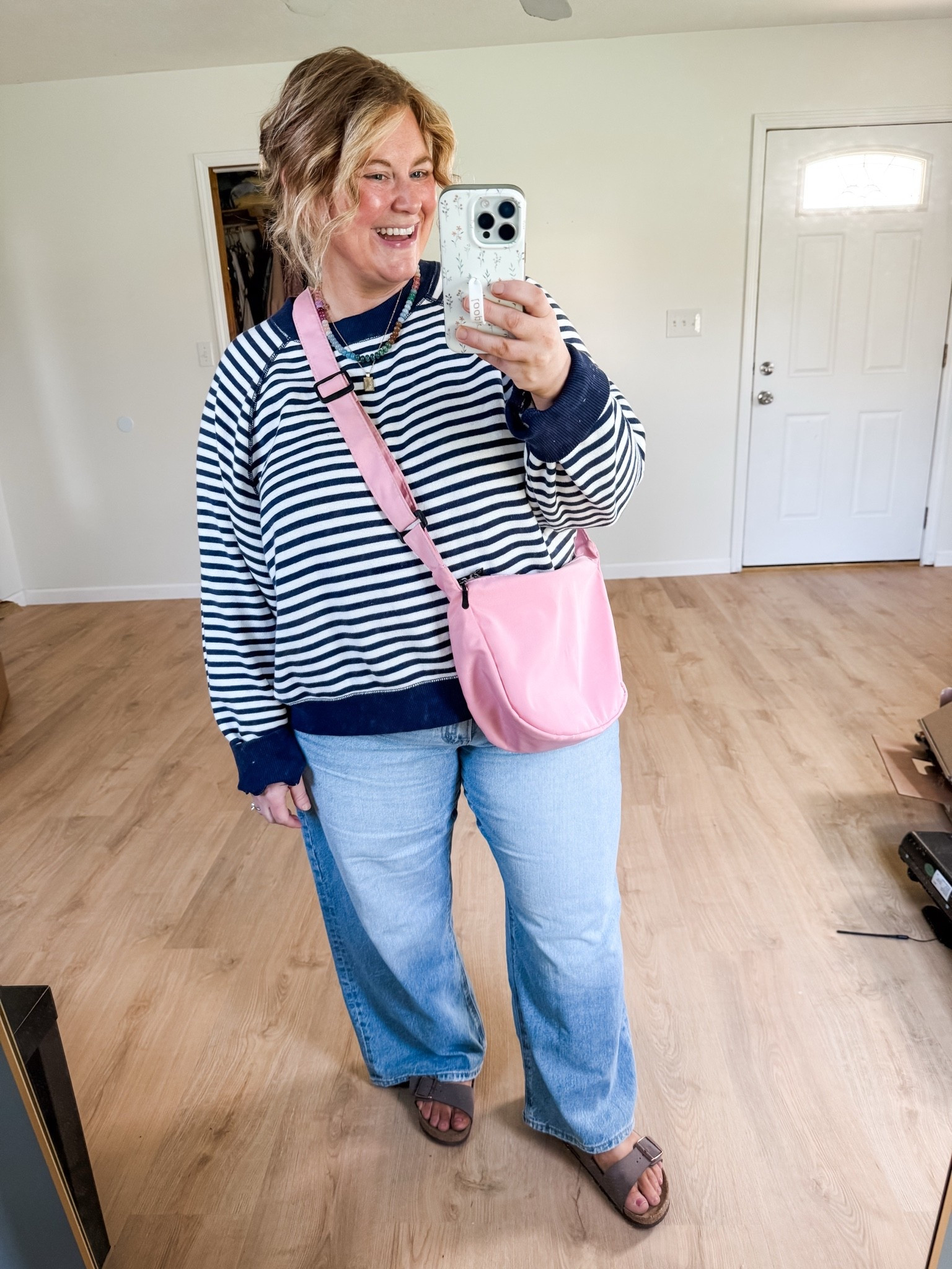 I love this stripe sweatshirt from Aerie, wearing a large! Also loving these jeans from American Eagle, wearing an 18 short. Added the pink bag and necklaces to make it extra fun.

#LTKootd #LTKSeasonal #LTKMidsize