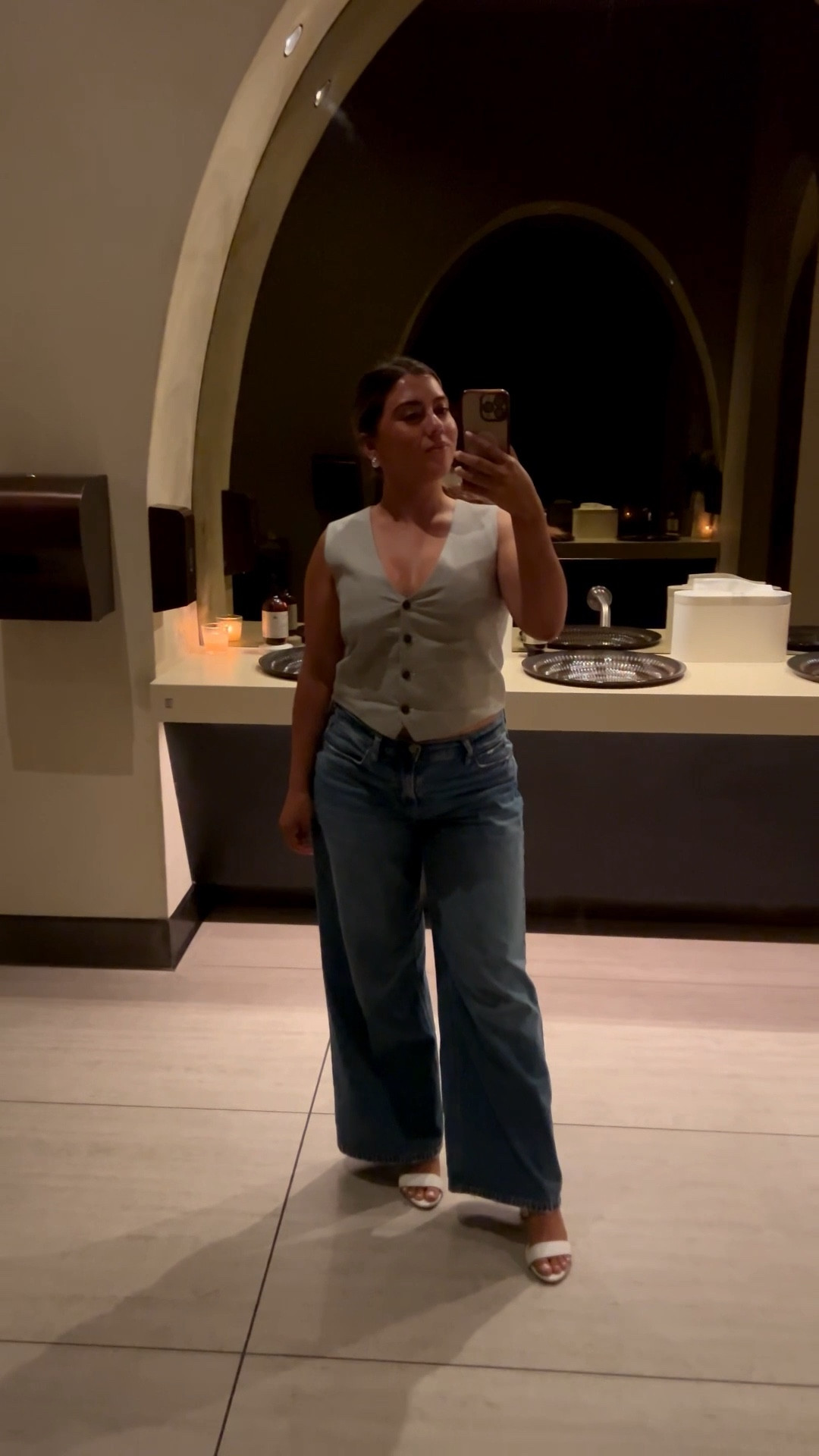 This look is a chic take on casual night-out style. The tailored vest top paired with wide-leg jeans gives that perfect mix of structured and relaxed, while the white heeled sandals elevate the whole outfit. It’s an effortless cool-girl vibe that works for dinner, cocktails, or a stylish date night.

#LTKFallSale