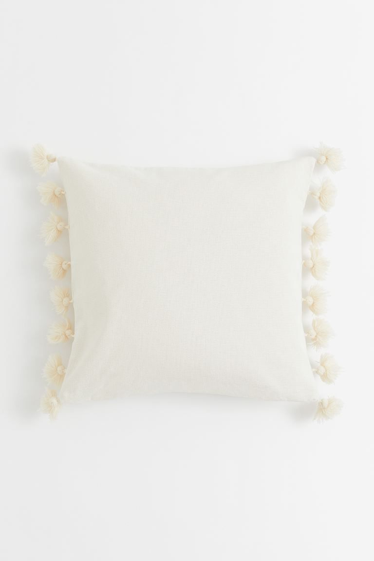 Conscious choice  Cushion cover in cotton canvas with tassels at edges. Concealed zip.Composition... | H&M (US)