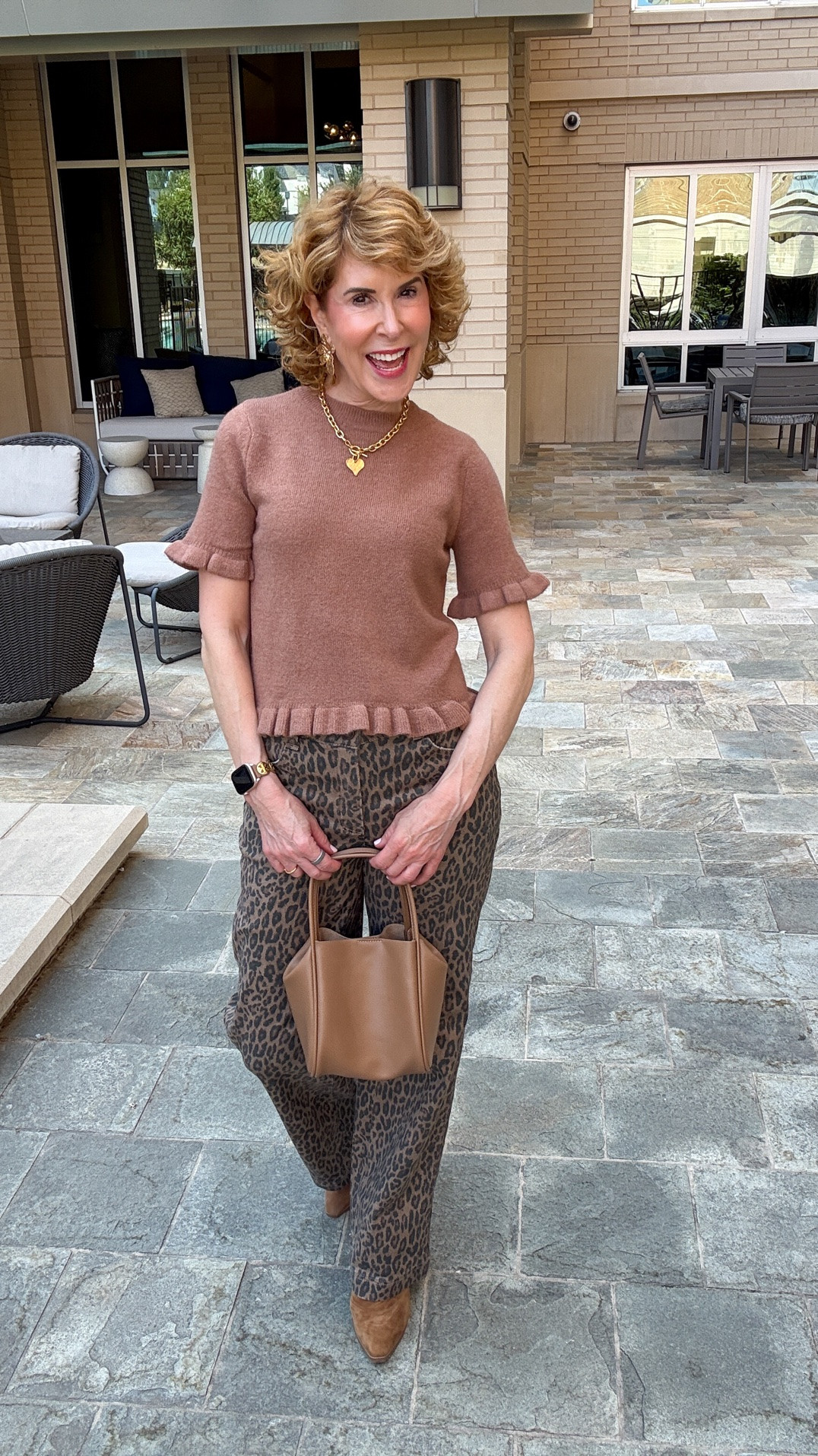 Fall outfit idea featuring 40% off leopard print wide-leg jeans with a flattering high-rise contoured fit, paired with an up to 50% off brown ruffle short-sleeve sweater available in 4 colors. I finished the look with brown suede ankle boots, a structured cognac handbag, and gold heart jewelry for an easy elevated casual fall outfit for women.

#LTKootd #LTKOver40 #LTKSaleAlert