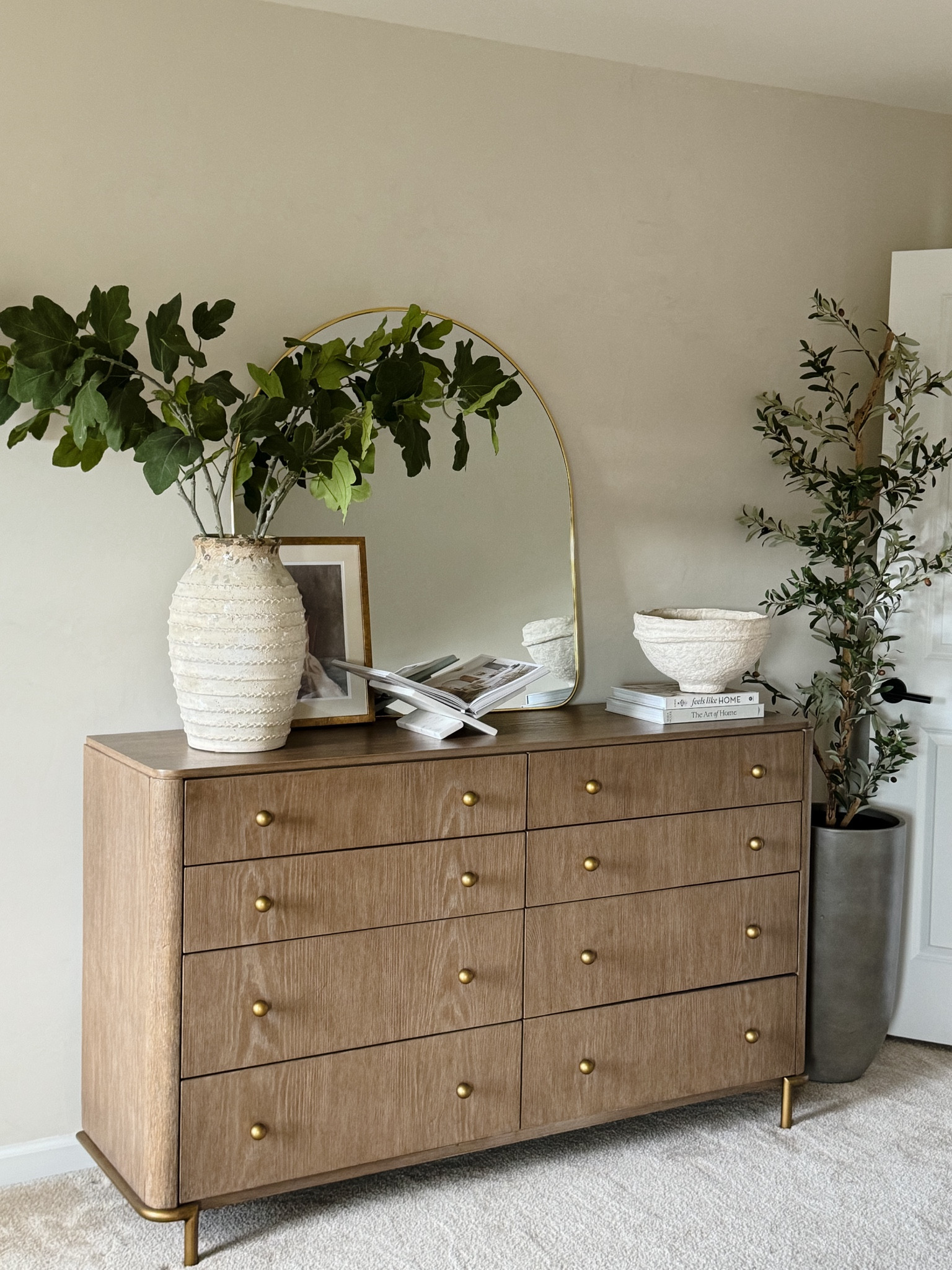 Transforming my bedroom one piece at a time with @Wayfair!  I recently got this mid-century modern dresser with a touch of vintage that meets all my storage needs. Besides having 8 drawers; I am loving the rounded corner edges, sand wash wood finish, and the aged brass round knobs. I styled it with an arched mirror and other decorative pieces.

#wayfair #wayfairpartner

#LTKxWayfair #LTKSeasonal #LTKHome