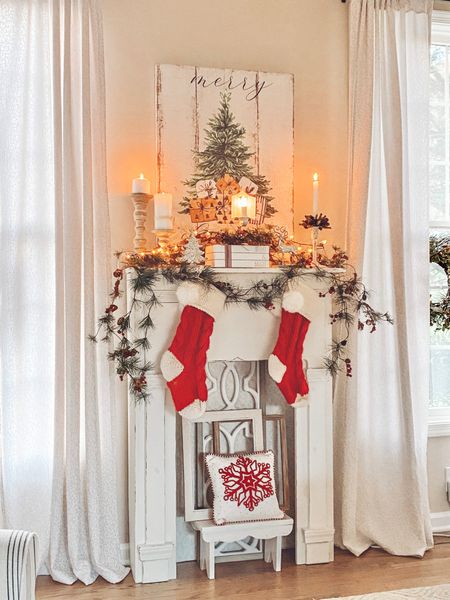 Christmas fireplace and mantle decor. Here I used a wispy garland to add some whimsy to my faux fireplace. The Santa print is one of my favorite prints which is linked. 

#LTKHoliday #LTKSeasonal #LTKhome