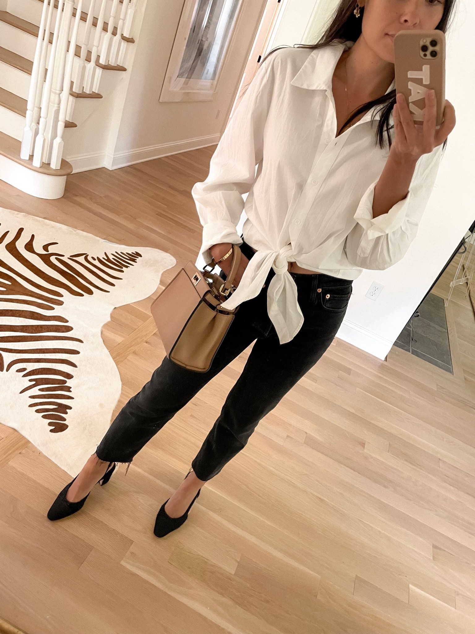 Kat Jamieson of With Love From Kat wears a fall outfit. Black jeans, white button down shirt, tan handbag, black block heels, neutral style, fall style. 

#LTKstyletip #LTKshoecrush #LTKSeasonal