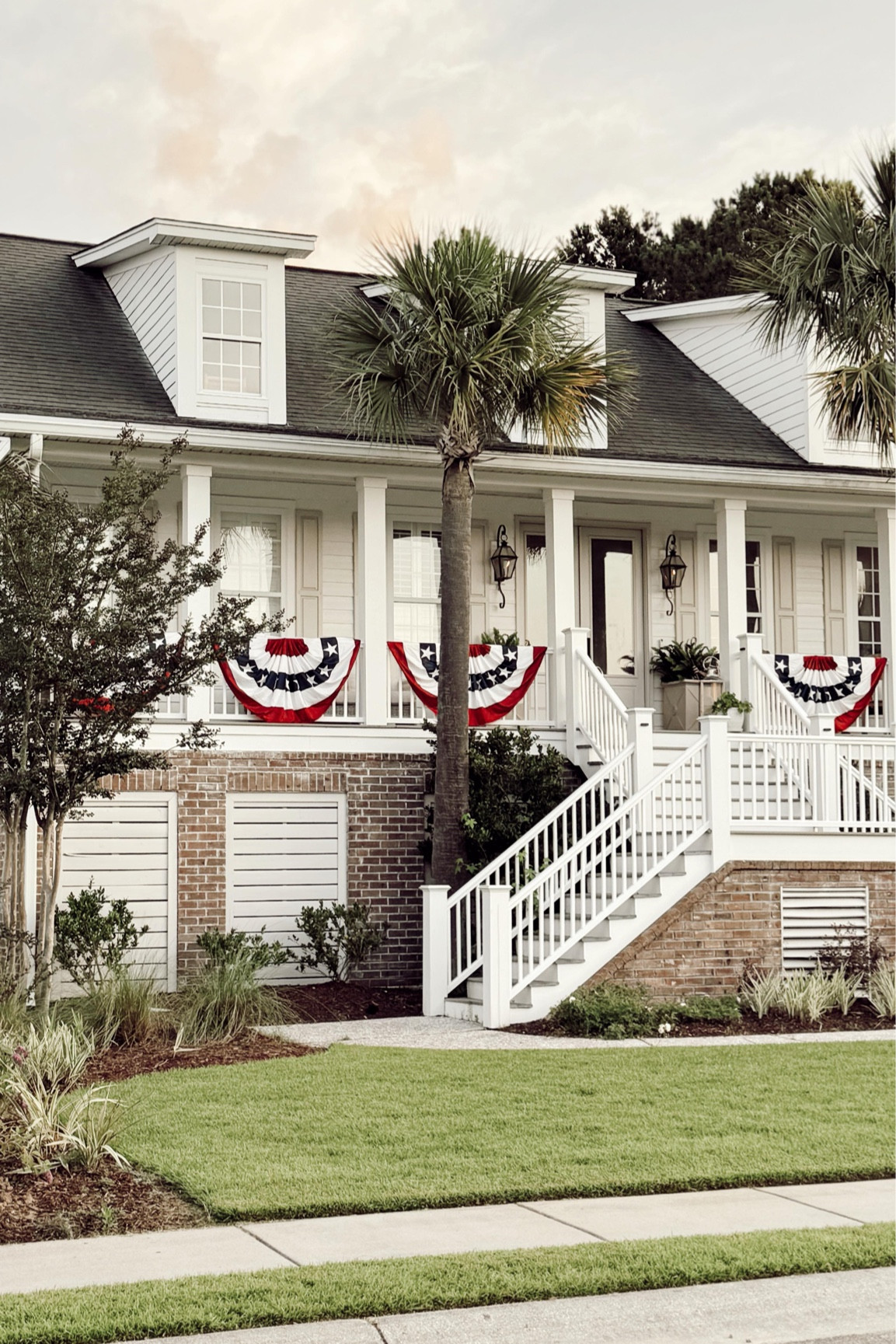 Making our coastal Charleston home ready for the holiday weekend 🇺🇸. I’ve wanted to add buntings to the porch for the longest time and found these for a great price! Grab them for the weekend & for the Fourth of July. Shop my porch, outfit, and decor by commenting FLAG and I’ll DM it all to you! 

#coastalhome #charlestonhome #cottagedecor #frontporch #southernliving #bhghome