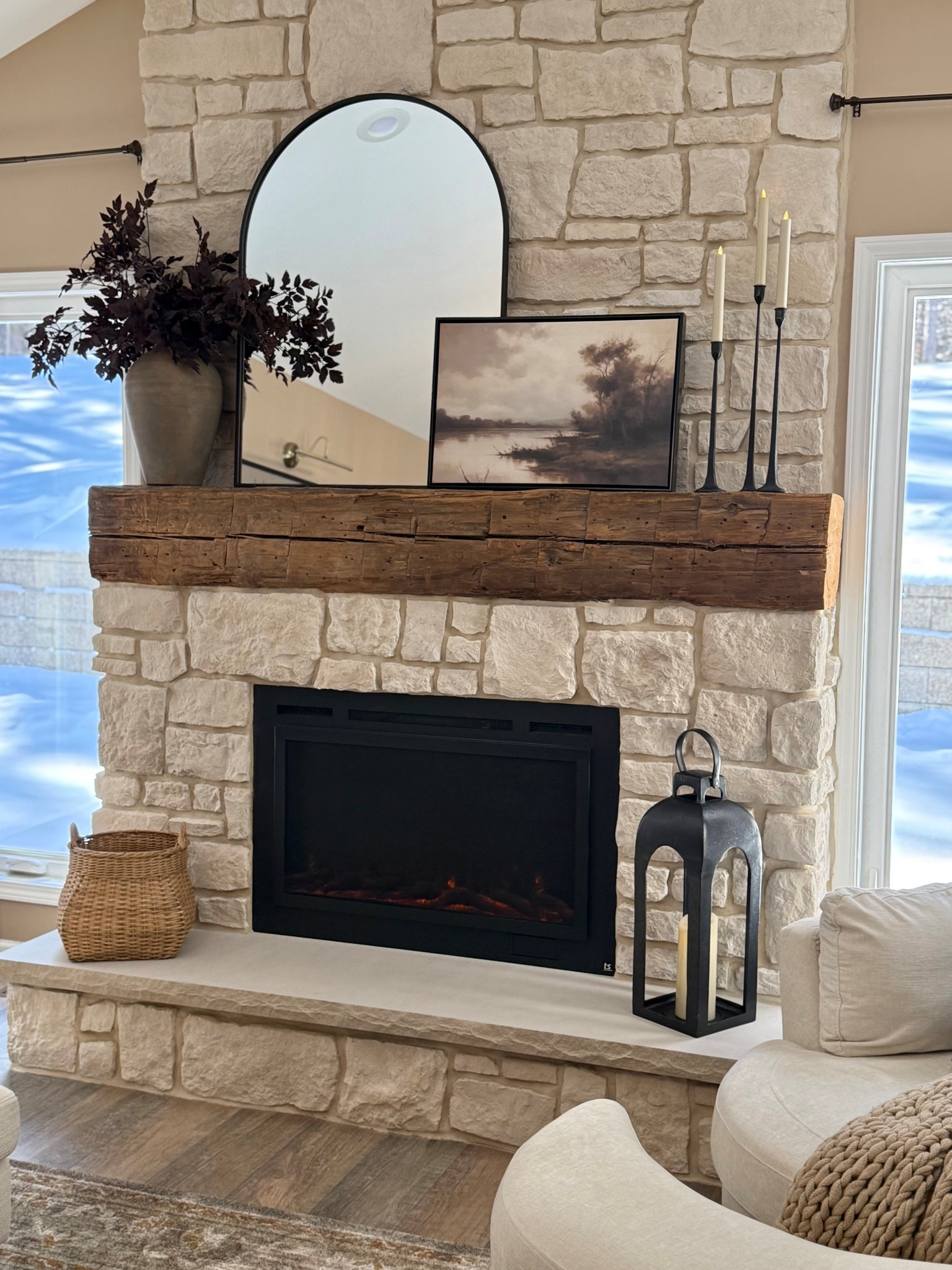 Stone Fireplace Mantel Styling with Neutral Decor

Follow @farmtotablecreations on Instagram for more home styling and decor finds.

A stone fireplace like this naturally becomes the focal point of the room, so keeping the mantel styling simple and layered works beautifully. An arched mirror adds height and reflects light, while framed artwork brings in a soft landscape element. The vase with greenery and tall taper candles help balance the arrangement and add warmth, creating a cozy, collected look that feels both relaxed and elevated.

#fireplacemantel #manteldecor #livingroomdecor #lanterns #vasedecor #wallart #candlesticks #neutraldecor #livingroomfurniture

#LTKHome #LTKSaleAlert