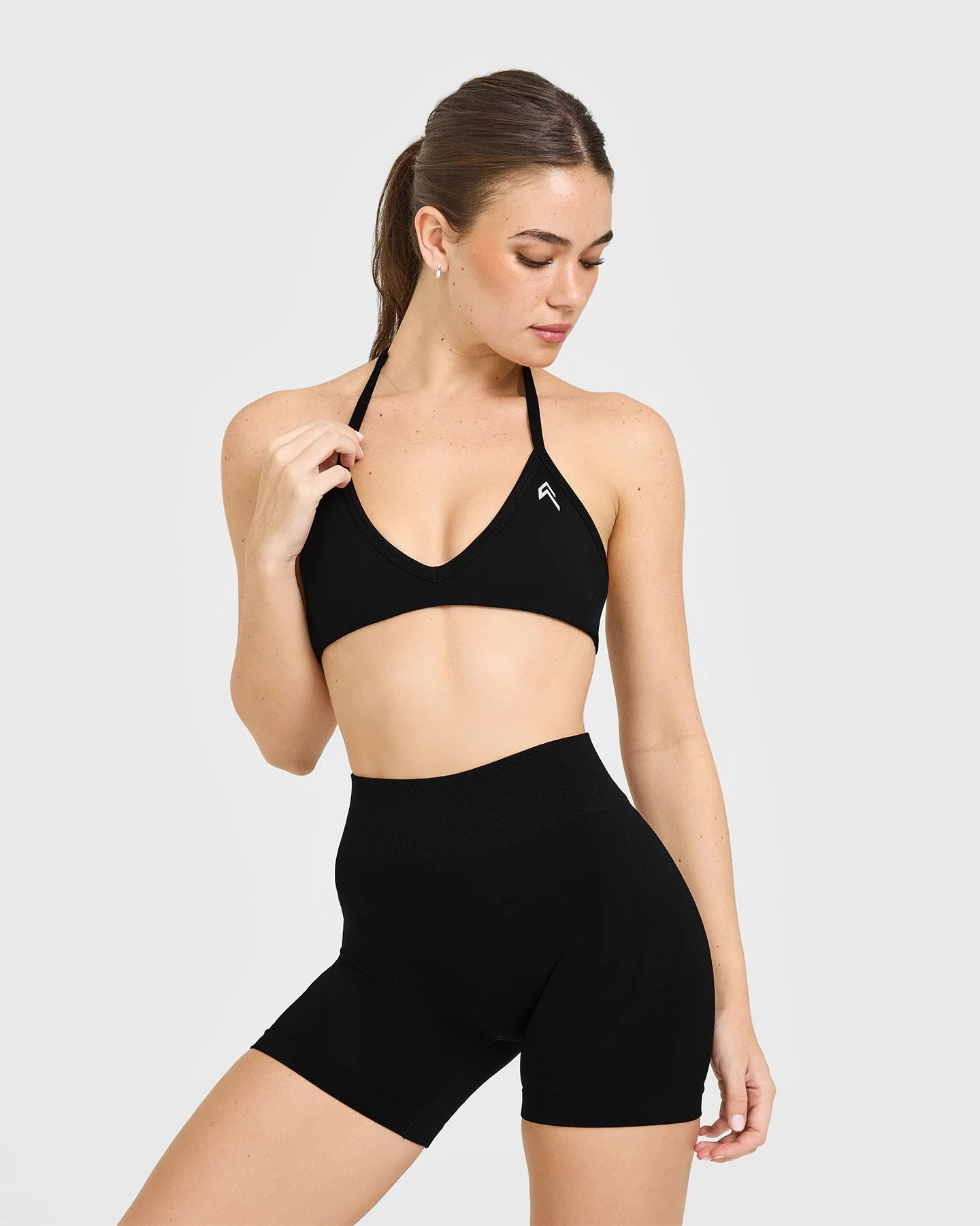 EnhanceLift™ Seamless Minimal Halter Neck Bralette with White Logo 
 Black | Oner Active (UK / US)