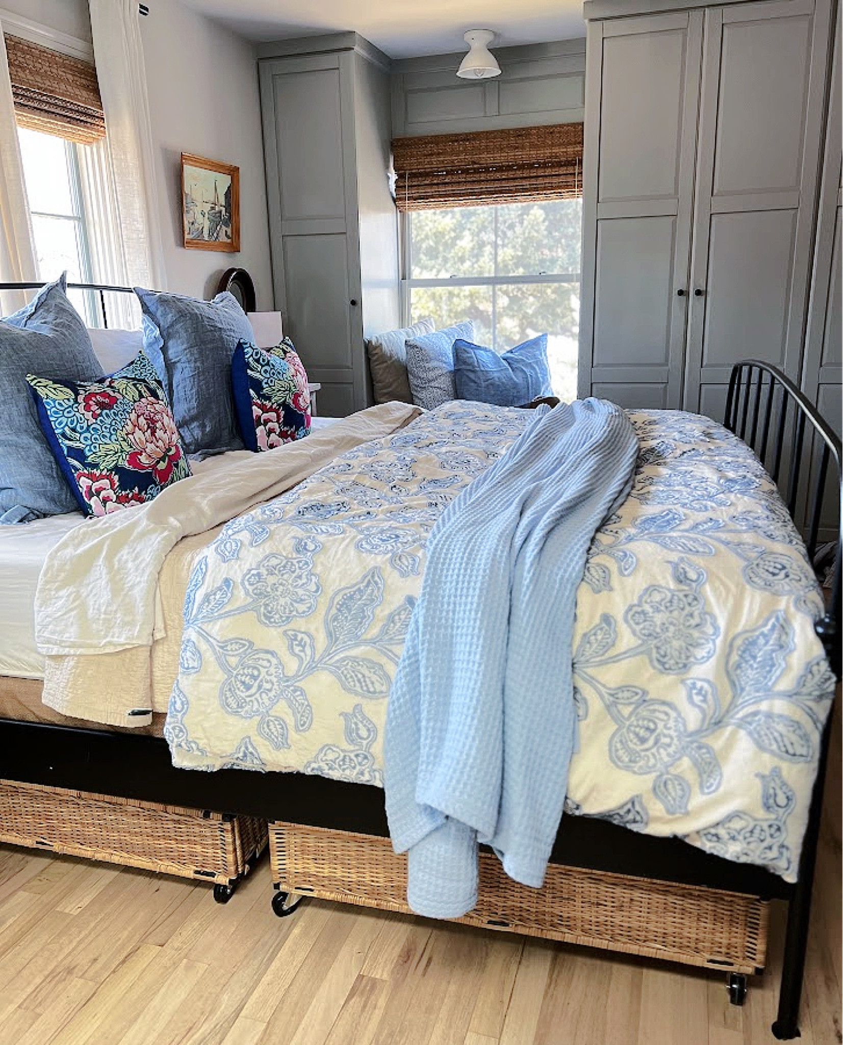 Master Bedroom details.. blue and cream floral duvet, king size waffle weave light blue blanket, under bed rolling storage (IKEA) , cream sheets and quilt, floral pillows, blue linen euro shams from Lands End, burlap box spring cover,  linen curtains, black curtain Rod , woven windows coverings (Lowes) , black metal bed (IKEA) , wicker Demi John, down alternative insert all linked below! 

#LTKFind #LTKunder100 #LTKhome