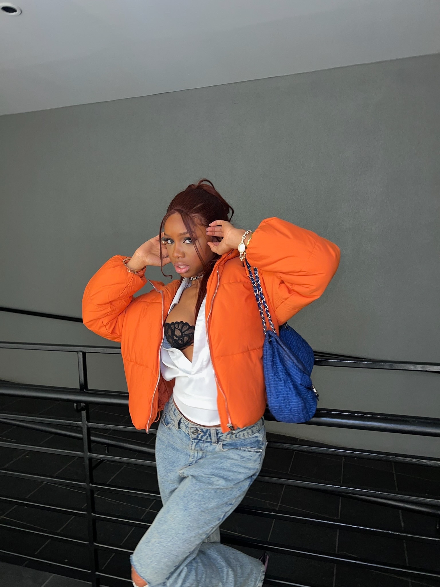 Causal winter outfit idea, orange puffer jacket paired with white slit top and fenty black bra, blue ripped jeans and vintage chanel   

#LTKstyletip #LTKHoliday #LTKSeasonal