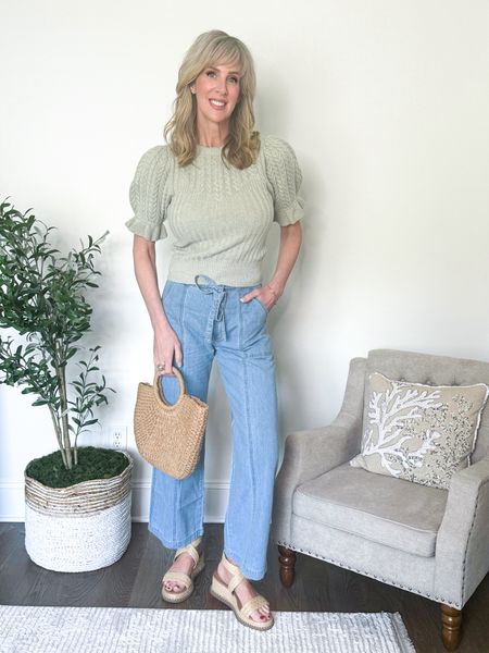 A beautiful puffed sleeve, ruffle trim sweater in light sage paired with a lightweight tie front denim trouser jean. An easy but chic spring look.  

Wearing a medium in sweater; size 29 in jeans (sizes up one size) as they have no stretch.  Sandals run true to size.  

#LTKStyleTip #LTKOver40 #LTKSeasonal