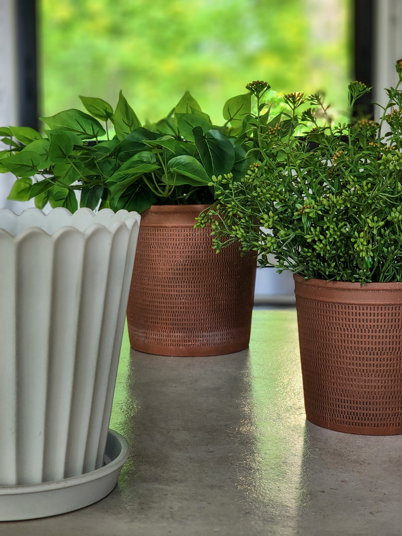 The modern rust / brown textured planters are my favorite. Filled with a variety of faux plants and artificial stem bundles, they will be the perfect addition inside our home. The cream fluted scalloped ceramic planter might become an elegant trash can, but I’m still mulling that over. 

#LTKFindsUnder50 #LTKHome