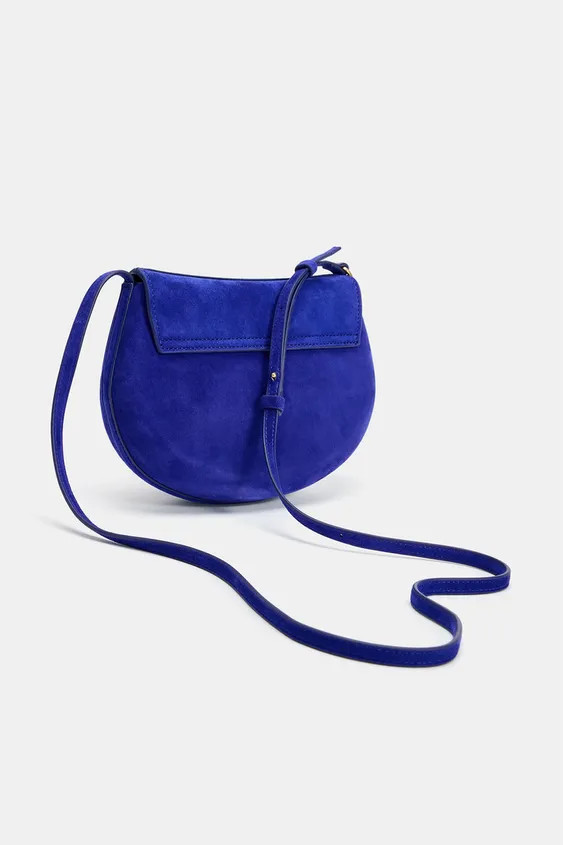 Leather crossbody bag. Adjustable strap. Interior zip pocket. Flap with metallic clip closure.Hei... | Zara US