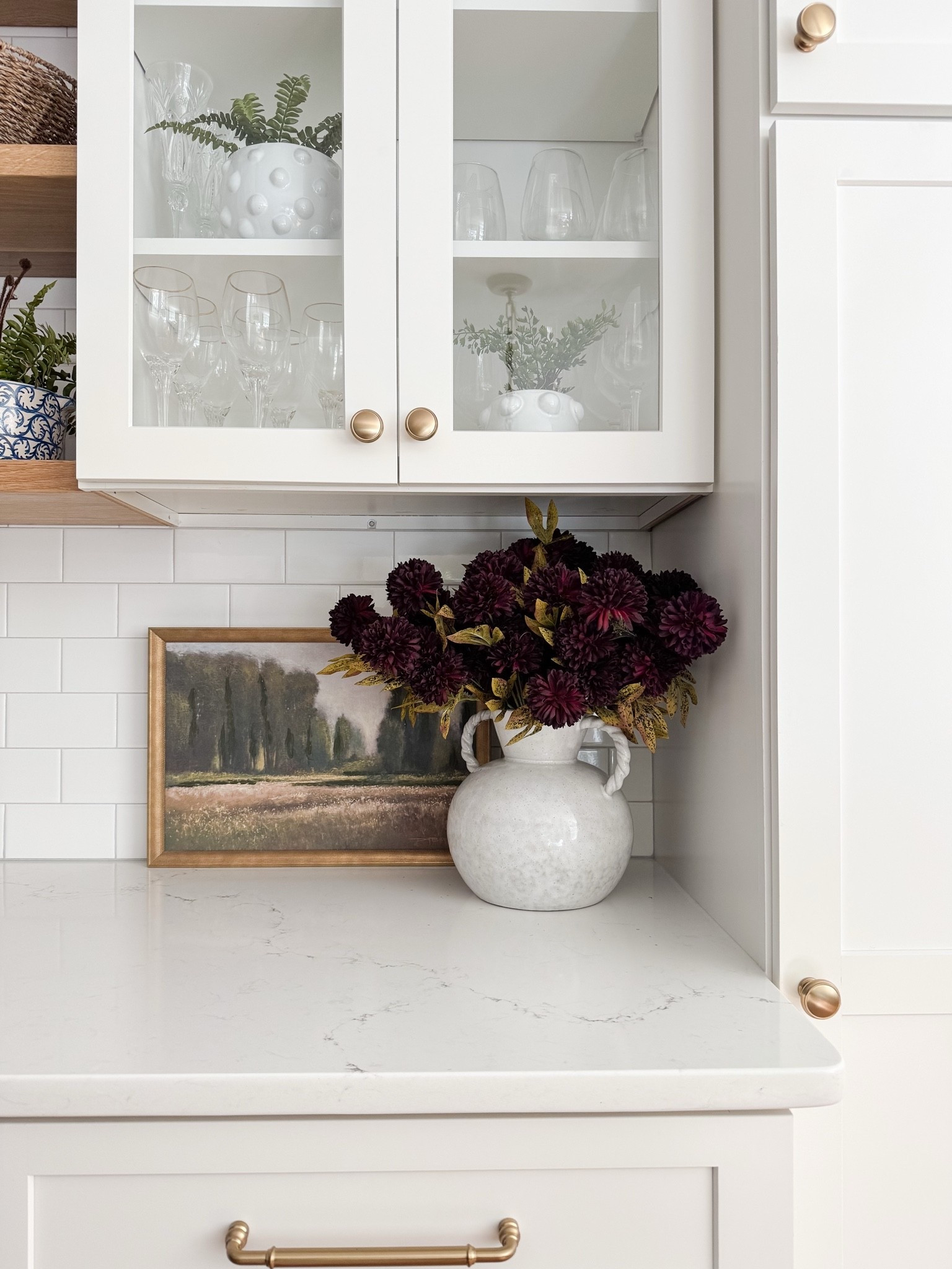 How to style stems in a pretty vase. This cape cod coastal kitchen keeps everything light, layered, and beautifully organized. Cape cod kitchen, coastal kitchen cabinets, glass cabinet styling, neutral kitchen decor, open shelf kitchen styling, amazon finds home decor, coastal neutral kitchen, sherri calnan home

#LTKHome