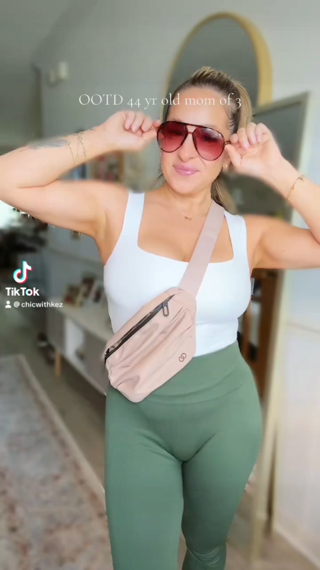 Sporty & chic ✨ This OOTD is all about comfort that still looks put together — a classic white tank, high-rise green leggings, my everyday crossbody belt bag, and oversized sunnies. Perfect for errands, school drop-off, or just staying active while looking cute! Linked it all for you here 💕 #LTKfit #MomStyle #OOTD

#LTKStyleTip #LTKPetite #LTKActive