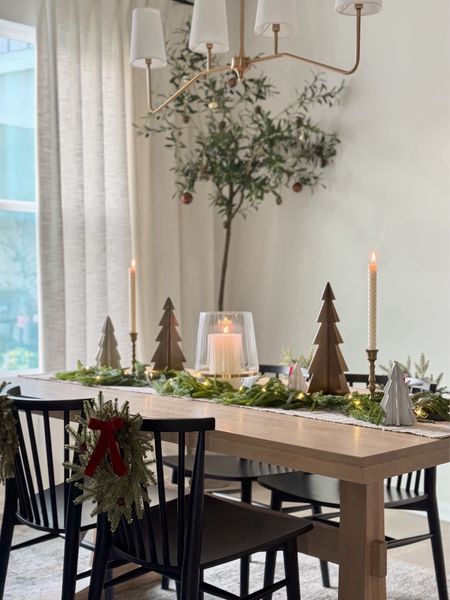 Holiday dining table centerpiece 🌲🕯️✨ 

All you need is a table runner, garland (or a few stems), candles, trees, and some fairy lights to create an elegant and cozy centerpiece. I like to keep my centerpiece all season long so I always try to set it up in a way that looks festive but still allows us to use the table on a daily basis/ see each other when we’re sitting down to eat (if that makes sense lol). 

Shop this post at the link in my bio and in the LTK app @whereheartresides. 

#LTKhome #LTKHoliday #LTKSeasonal