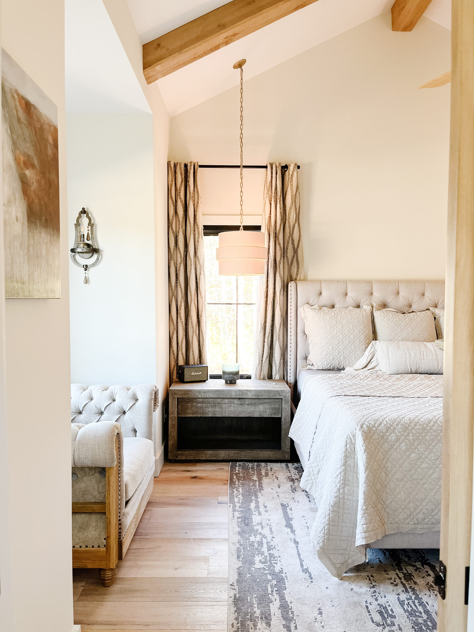 ✨ This modern farmhouse primary bedroom is designed for calm — soft neutrals, warm wood beams, and layers of inviting texture. The Belgian linen quilt and sheet set add effortless luxury, while the tufted bench brings timeless comfort to the space. It’s the kind of room that just feels good to unwind in. 

 