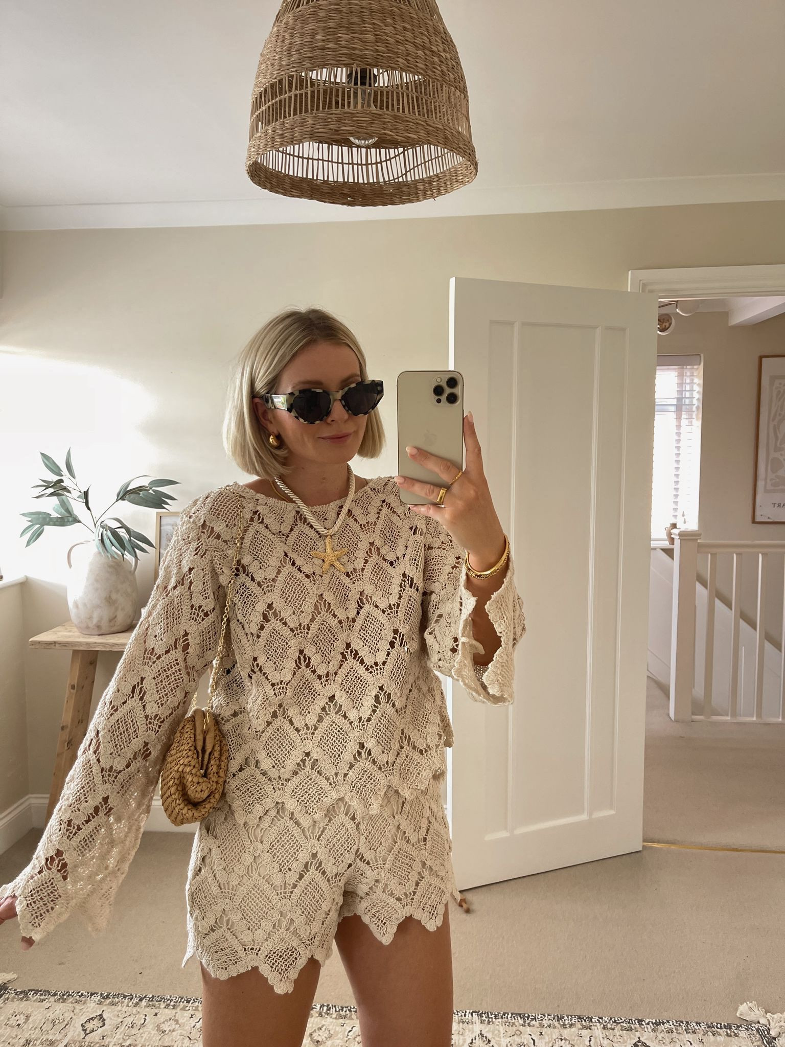 Chic summer festival & Ibiza outfit ideas - cream lace top & shorts Co-ord set from asos, beige suede cowboy boots, mango raffia clutch bag, starfish necklace, & other stories tortoiseshell cat eye sunglassess

#LTKsummer #LTKstyletip #LTKuk