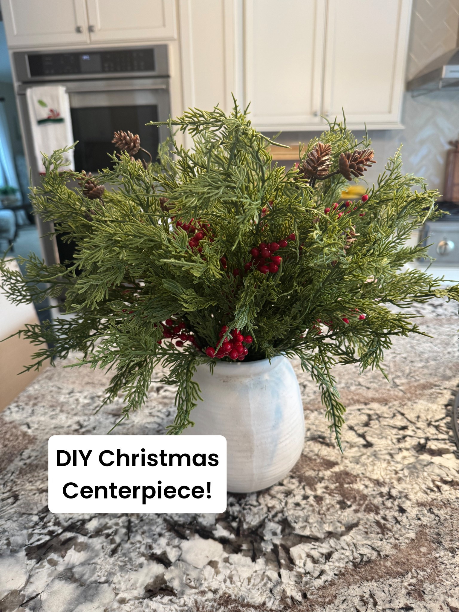 Christmas centerpiece, Christmas decor, Christmas decorations, faux stems, Christmas stems, faux berry stems, red berry stems, faux cedar stems, diy Christmas centerpiece, Amazon centerpiece, real feel greenery, real feel Christmas stems, pine stems, cedar stems, Christmas greenery, pine cone stems, cement vase, white vase, Amazon vase 