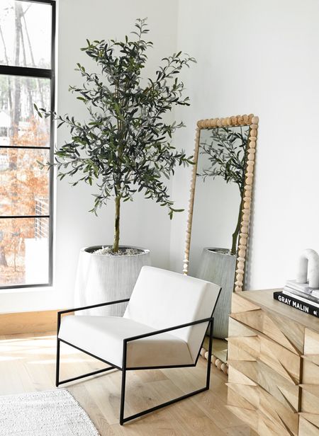 A little corner in our home featuring some of my favorite pieces.  The tree is an amazing option for an artificial olive tree…I love the shape.  I talk about this planter all the time.  It’s a personal favorite and comes in several size options.  While mirror is pricey but so special with the geometric wood detail and the clean lines are so beautiful. 

#LTKhome
