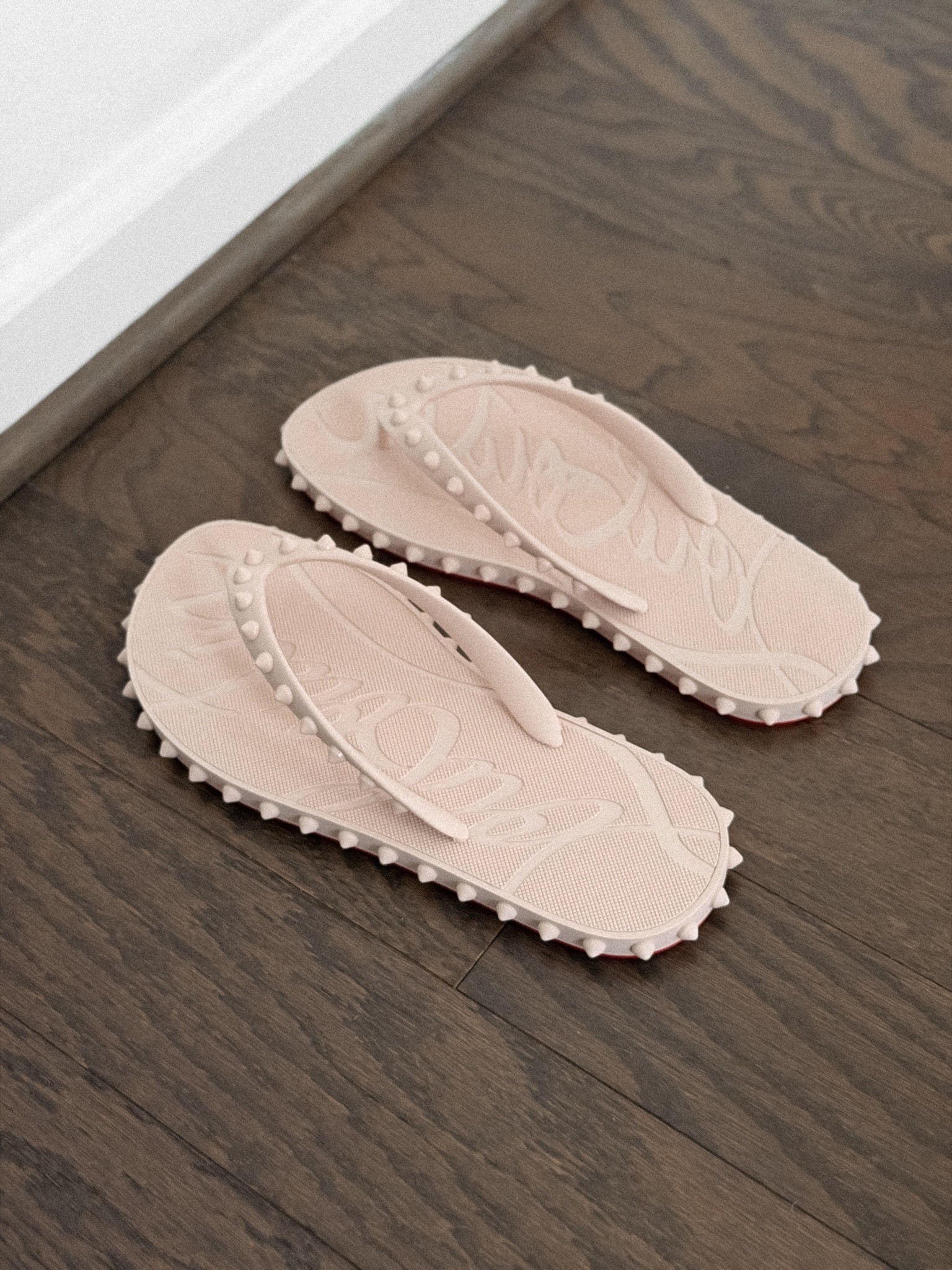 Christian Louboutin Super Loubi studded rubber flip flops in the color Leche
