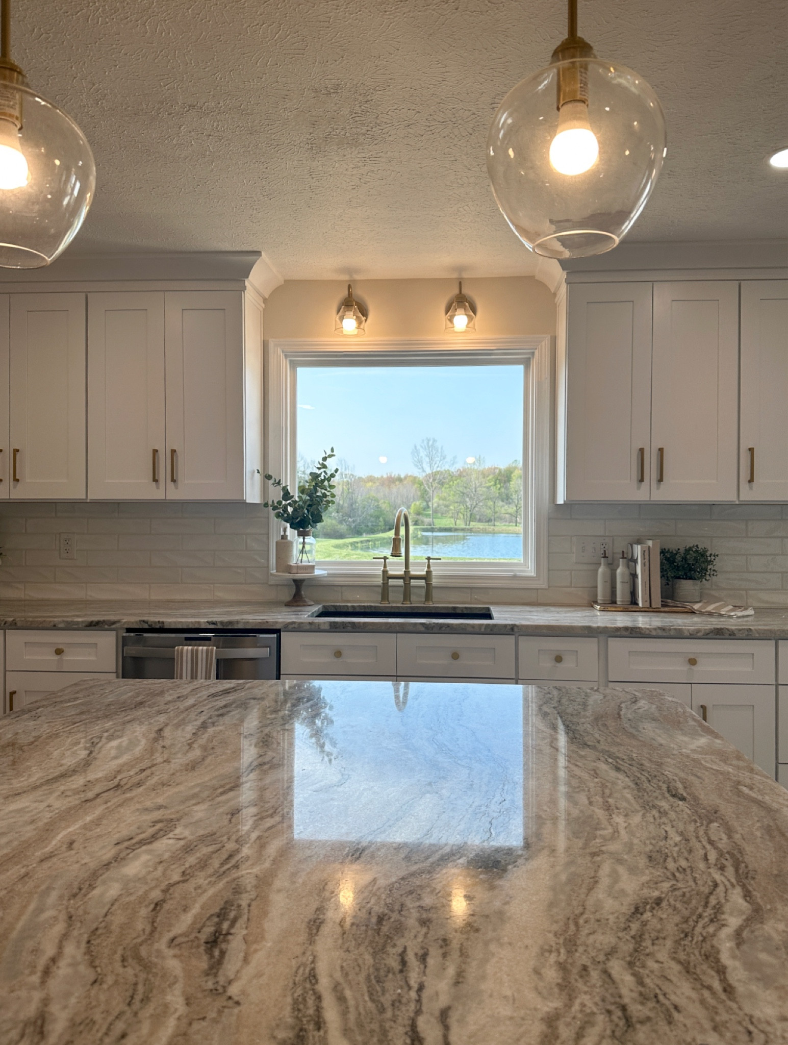 Kitchen remodel // quartz countertops// picture window // farmhouse // fantasy brown quartz // white cabinets // custom kitchen

#LTKunder100 #LTKunder50 #LTKhome