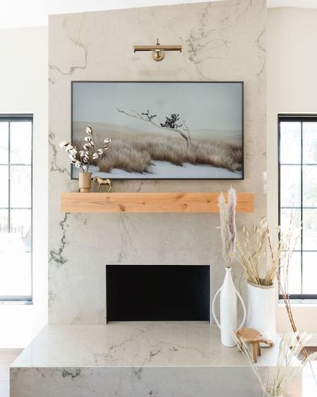 Modern farmhouse Fireplace 

We kept the decor neutral with some rustic accents. Fireplace mantel, dried stems, frame tv, picture light. 

#LTKSaleAlert #LTKHome