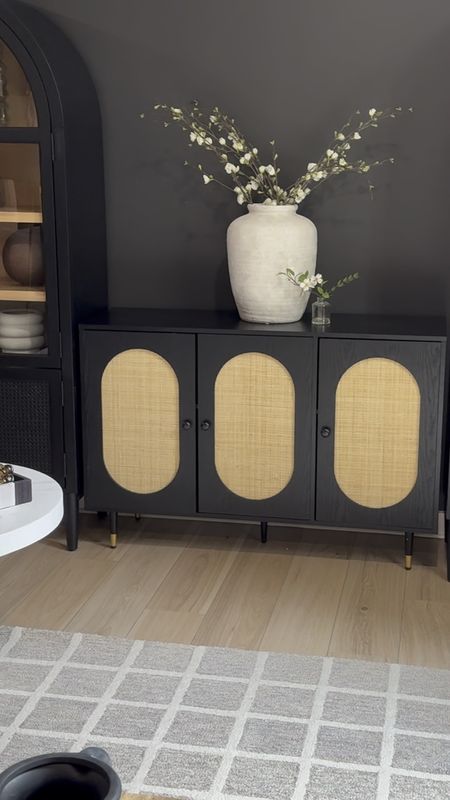 When designing family friendly spaces, I am a big fan of mixing classic investment pieces with affordable ‘trendier,’ finds to create a fantastic, polished look. 
I fell in love with the classic arched cabinets and was looking for something fun to tie them together. It took some patience to find the right piece, but I love how this black and rattan console table bridged the gap between the arched cabinets.

#LTKStyleTip #LTKHome #LTKFamily