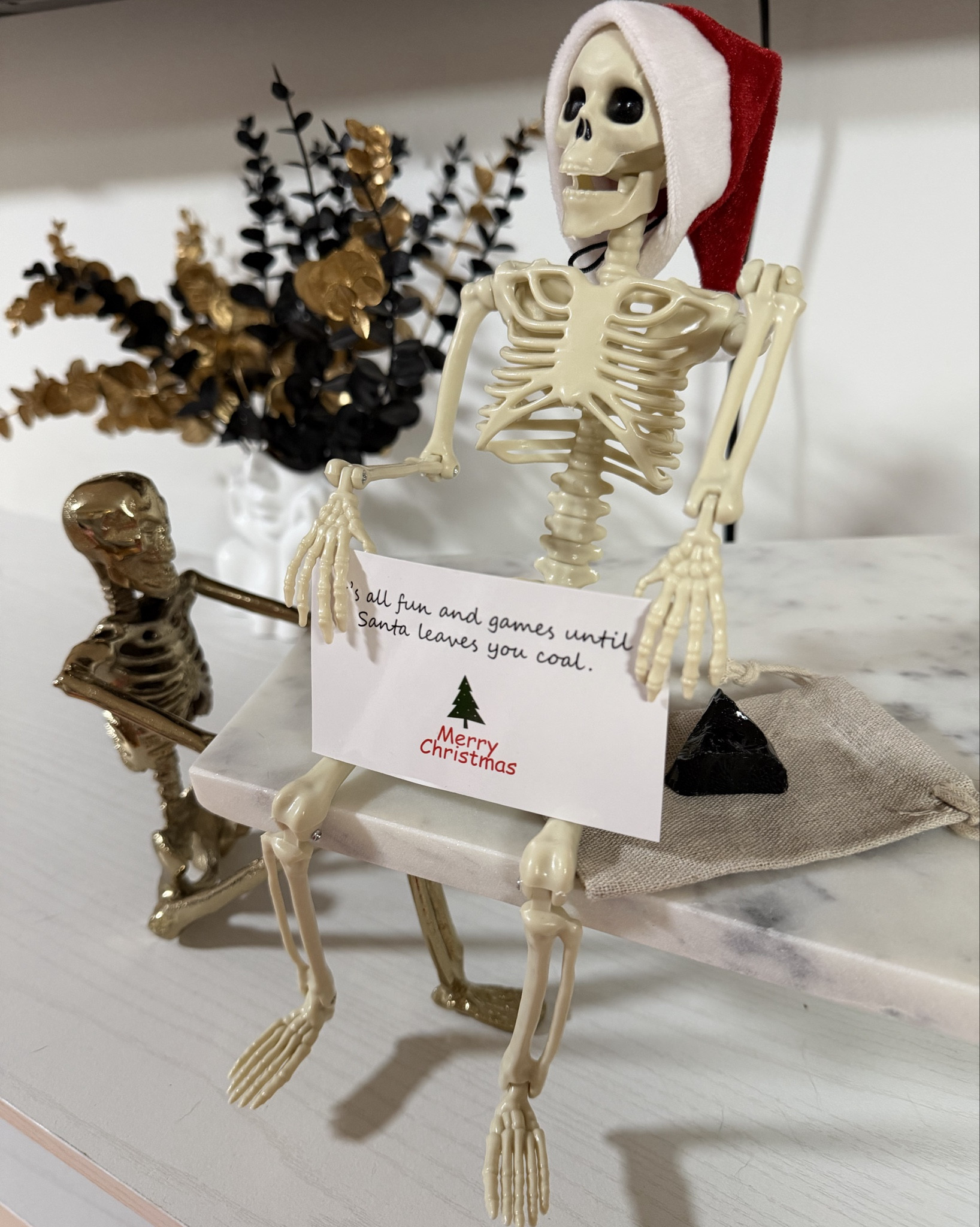 My version of Elf on the Shelf… except let’s be honest, this little guy is way too mean for kids 😂 And I don’t even have kids — but he fits my aesthetic a little too well.

If you’re into the whole spooky-holiday, glam-meets-skull moment like I am, this is your sign to make your décor fun. Mine is sitting on my marble skeleton tray holding a note that says ‘It’s all fun and games until Santa leaves you coal.’ Very on-brand for me and honestly? He’s not wrong.

#LTKGiftGuide #LTKHome #LTKHoliday