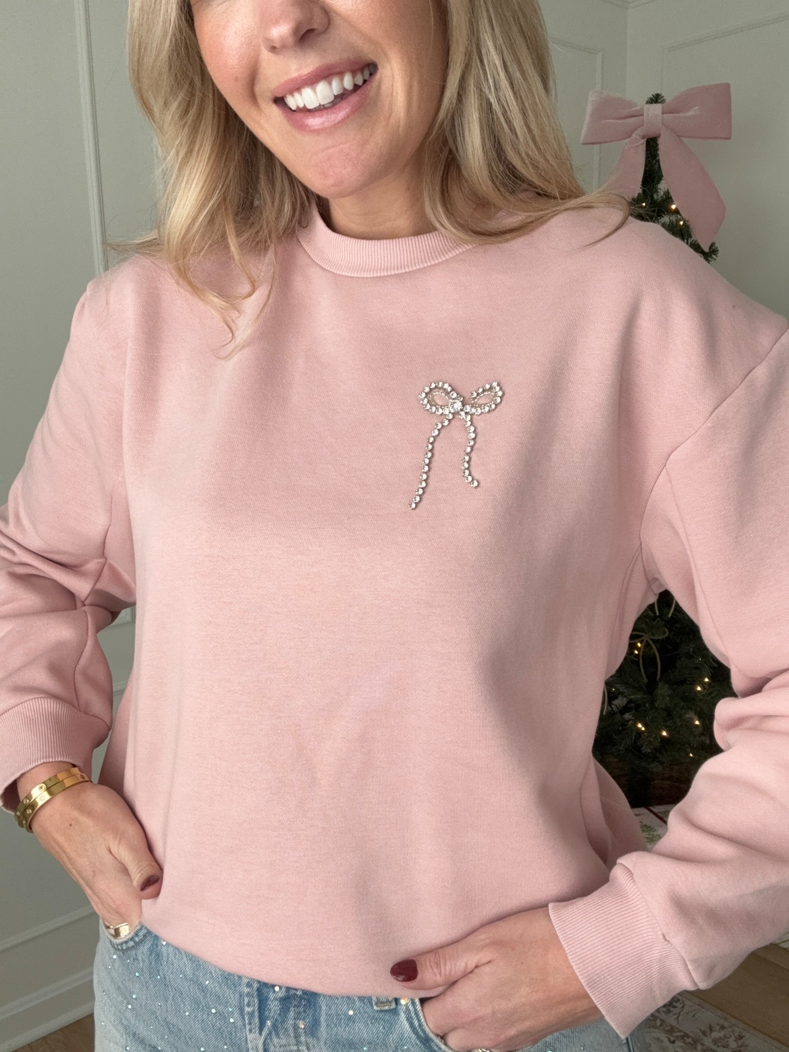 Casual holiday outfit - embellished jeans wearing a size 10 and bow sweater, wearing a med! Winter outfit 

#LTKHoliday #LTKFindsUnder50 #LTKMidsize