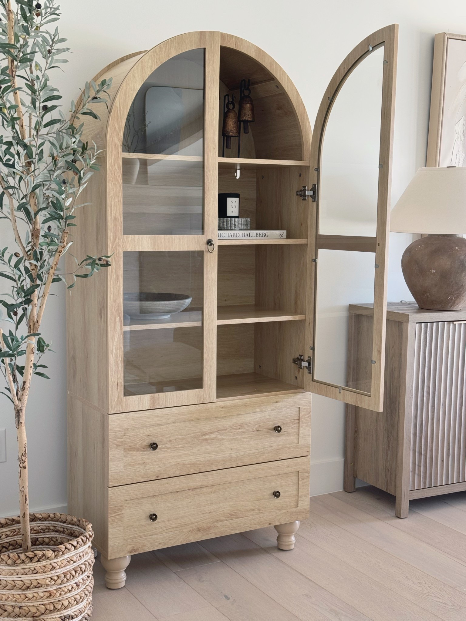 I still can’t believe this cabinet is from Amazon and under $260. The arched detail, light wood tone, and glass doors make it such a pretty and functional piece for any room. It’s a great budget-friendly find that looks way more expensive than it is!

#LTKHome #LTKStyleTip #LTKSaleAlert