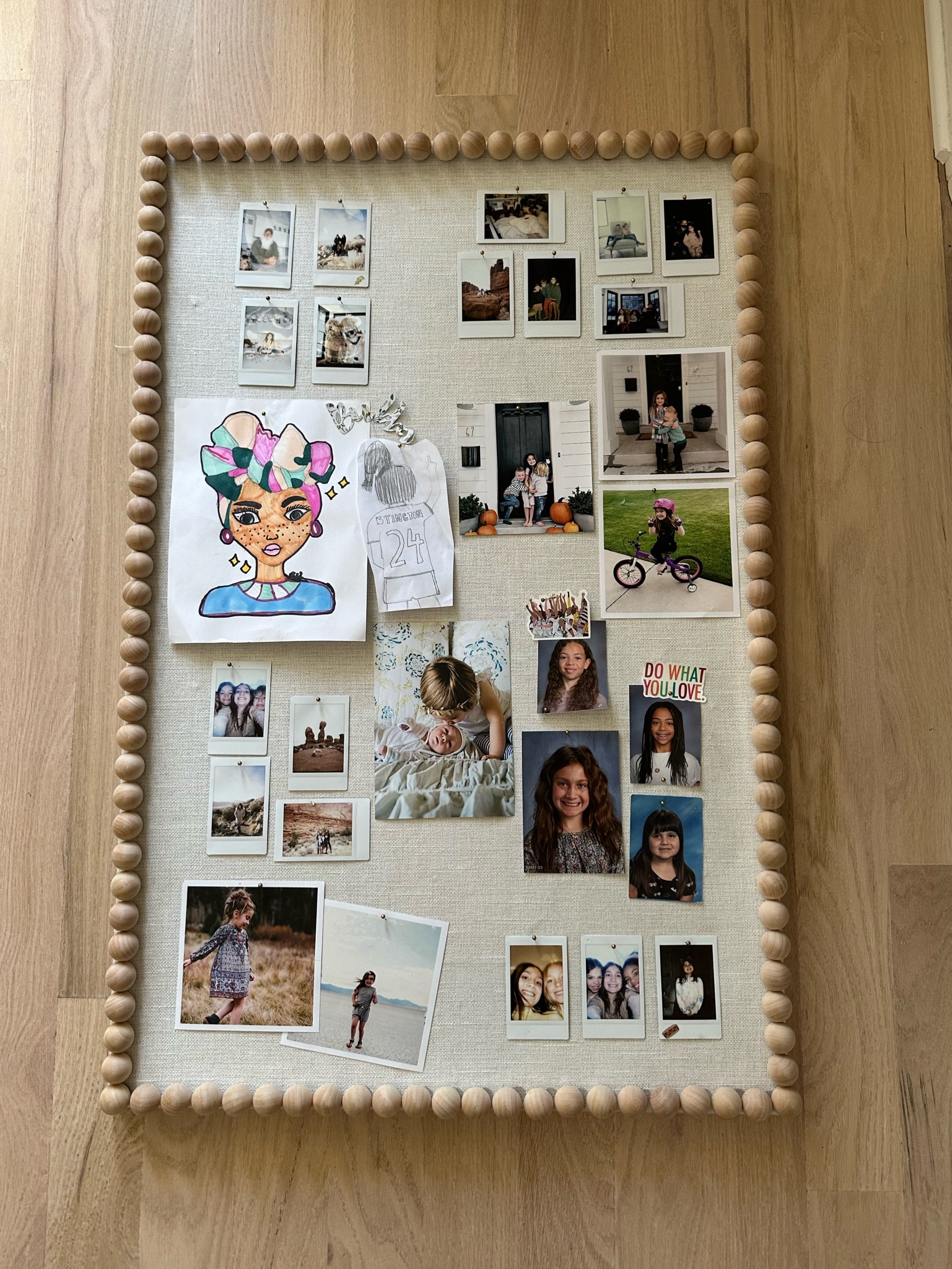 DIY pin board for a girls room. My daughter wanted a cute bulletin board for her bedroom, but all of the cute ones that went with her room were about $200. We decided to make this one and it was under $50. I bought a basic pin board from target, a yard of linen fabric (stapled around the back), and used gorilla glue to glue on a frame of wooden balls. It turned out so cute! 