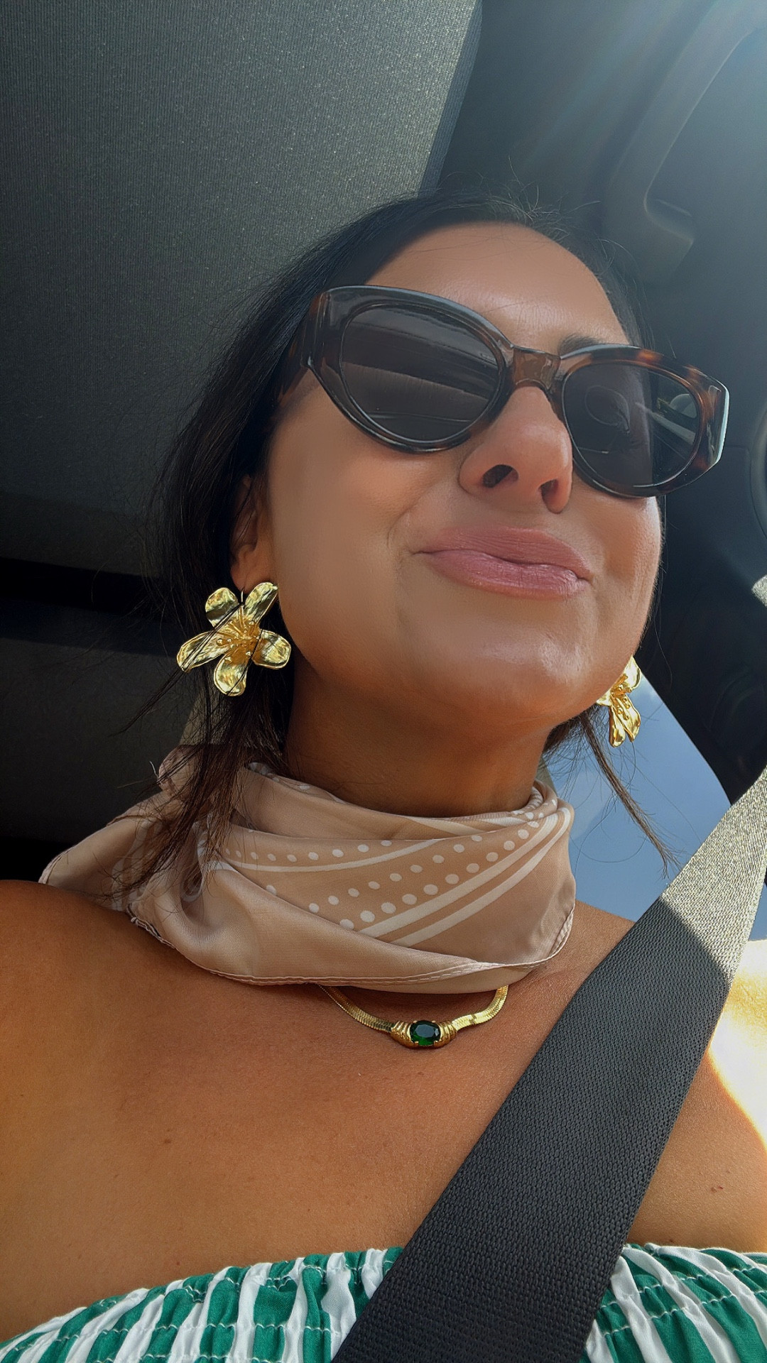 My favorite vacation outfit yet! A silk scarf, 90s trendy sunglasses,
Gorgeous gold accessories including a floral earring! The most luxurious perfume (Burberry HER), floral sandals and a chic striped sleeveless vacation dress in green! Included my favorite luxury top handle purse and sunscreen. Happy summer! 
