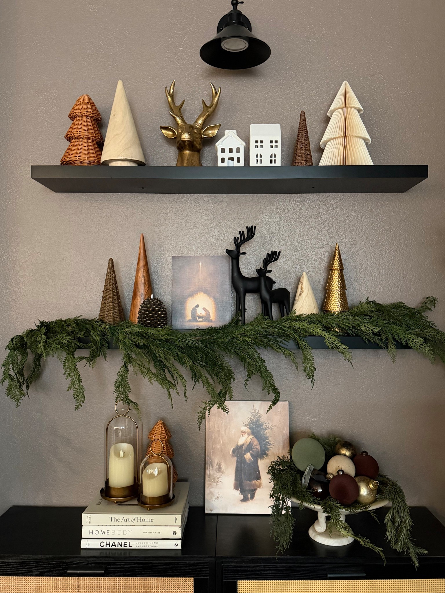 Simple Christmas shelf styling with table top trees, reindeer, Christmas village houses, garland, candles and artwork . Vary textures and heights for visual interest 

#LTKSeasonal #LTKHoliday #LTKHome