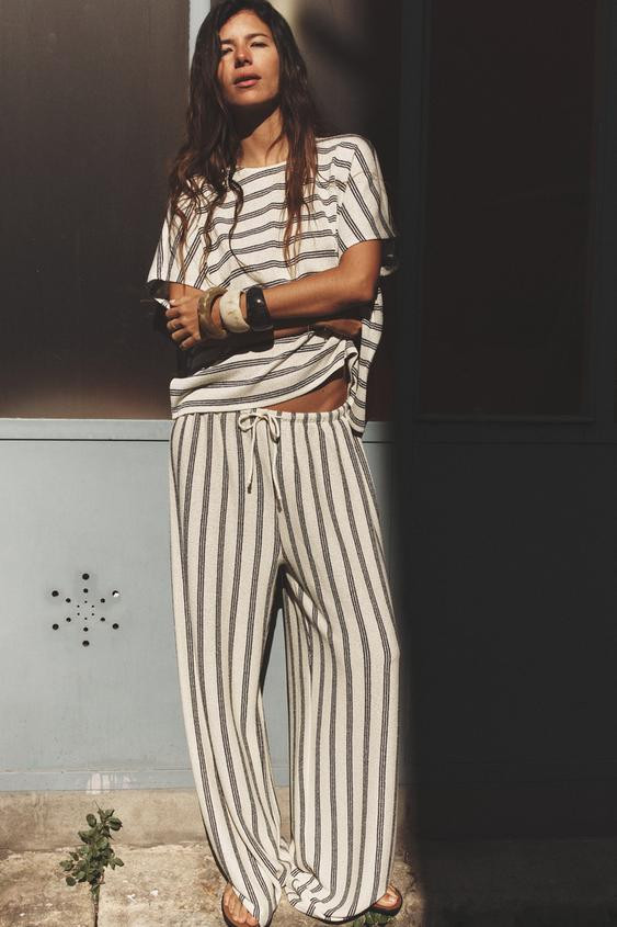 Pants made in rustic type fabric. High-waisted with elastic waistband adjustable with drawstrings... | Zara Canada