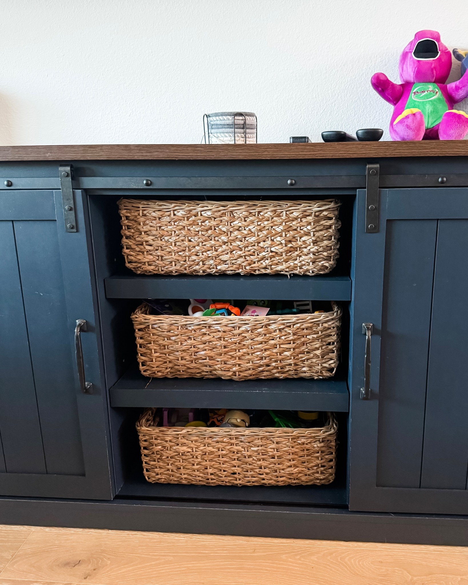 An easy living room toy storage solution I swear by 🙌 These basket storage bins fit perfectly inside our navy TV stand and help hide all the everyday toys while keeping everything within reach. Sharing a living room and playroom means getting creative with storage, and this setup keeps things looking tidy without sacrificing style. Plus, hidden cabinet storage = a must!

#LTKmomlife #LTKHome #LTKKids