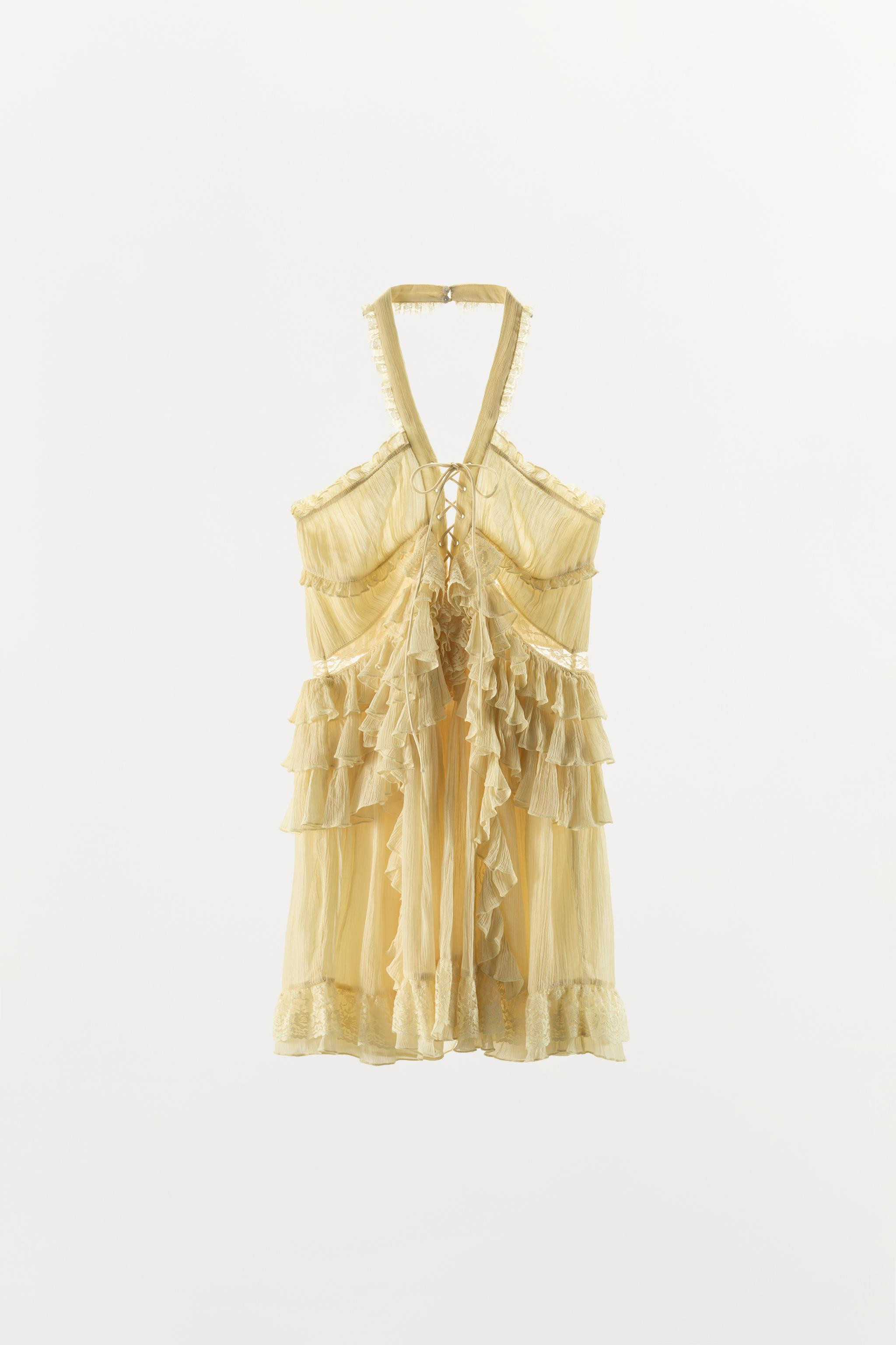 Short dress made from 100% viscose. Featuring a halter neck and a V-neck with adjustable tie deta... | Zara NL