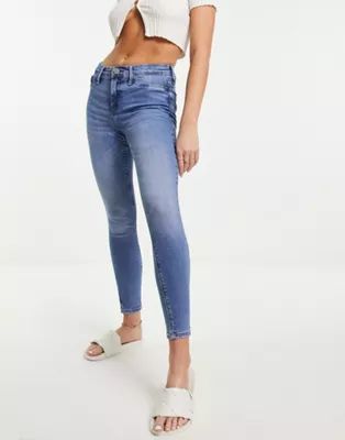River Island mid rise washed skinny jeans in mid blue | ASOS (Global)