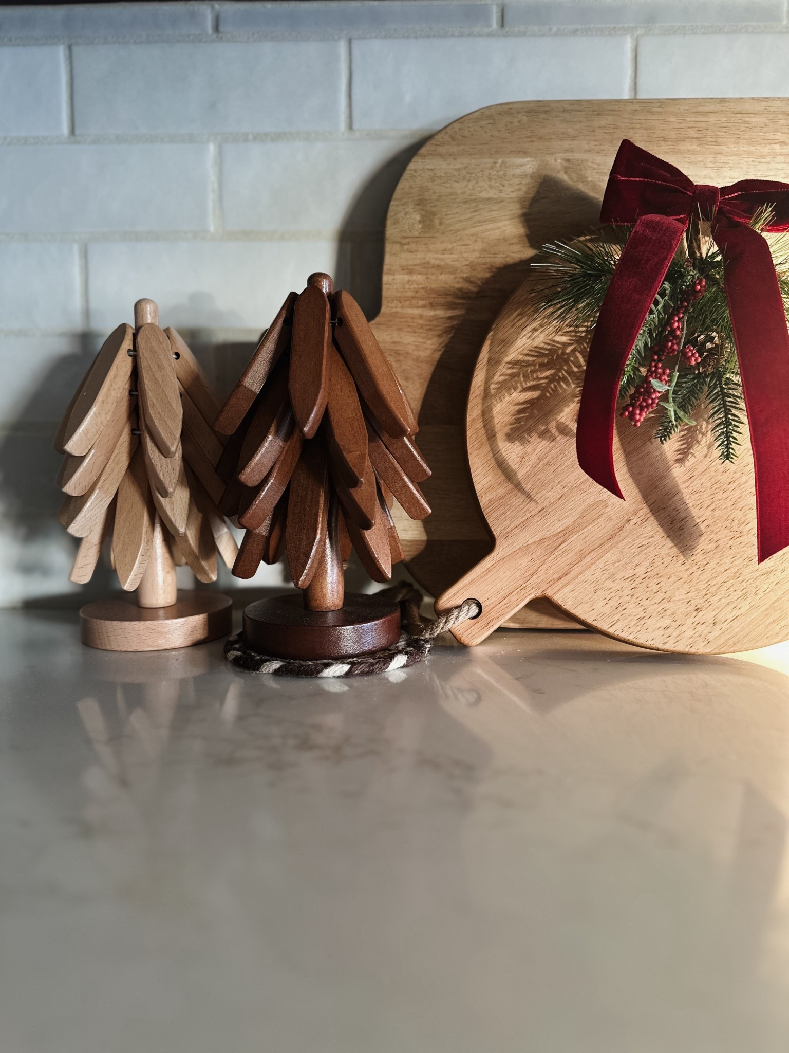 The cutest way to dress up counter cutting boards is to add a holiday sprig and velvet bow! Loving these wooden tree trivets! 

#LTKHome #LTKSeasonal #LTKHoliday