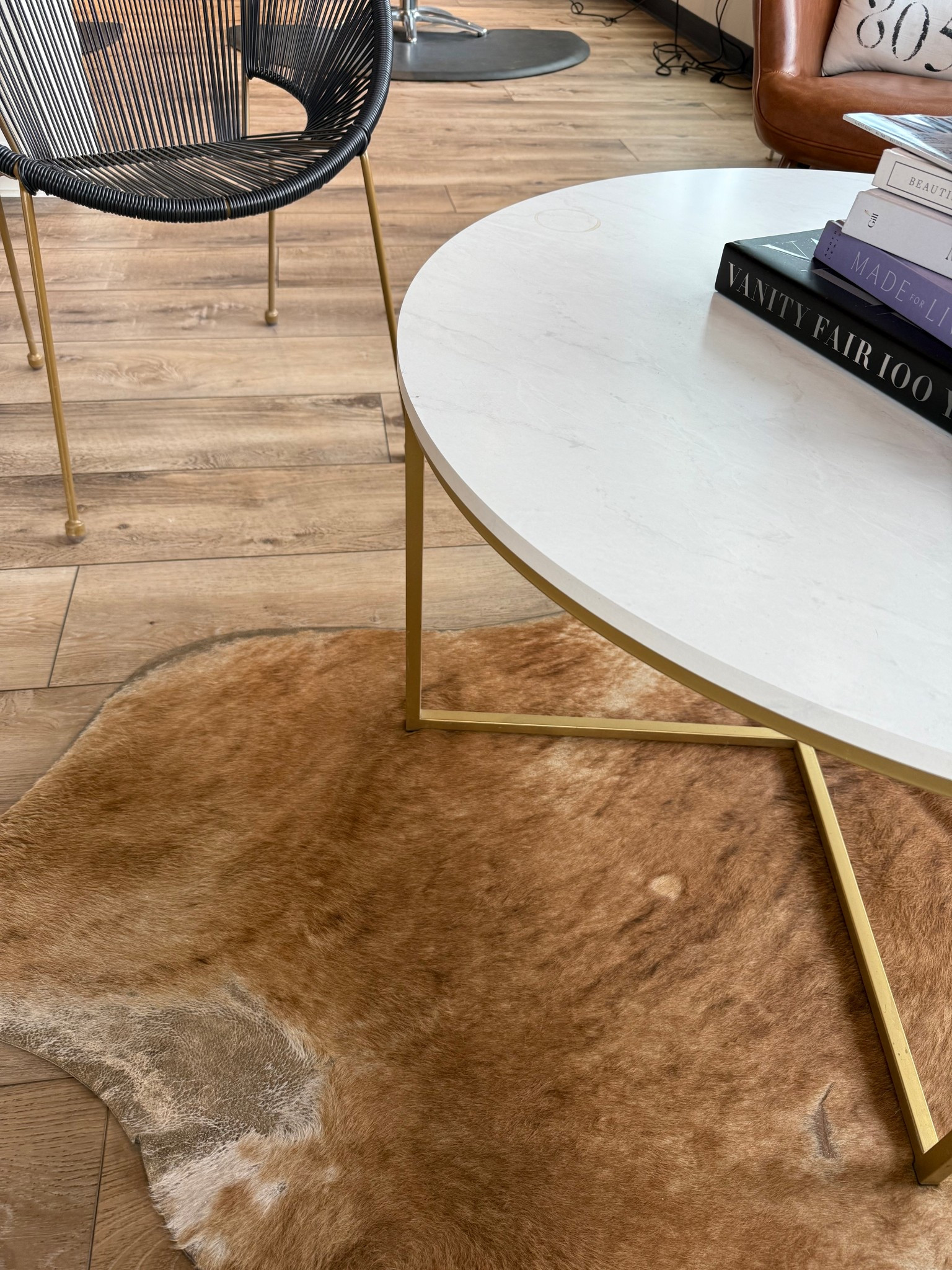 Rustic modern with gold textures and a faux cowhide rug. The chair is the perfect indoor outdoor furniture piece 

#LTKHome #LTKSeasonal #LTKSaleAlert