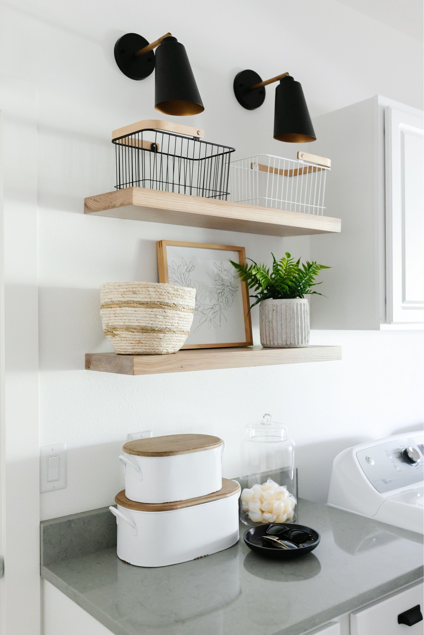 In my laundry room I have white oak shelves perfect for baskets and bins. On the countertop I have a pretty glass canister for my laundry pods and more bins for storing cleaning rags  

#LTKFind #LTKhome #LTKstyletip