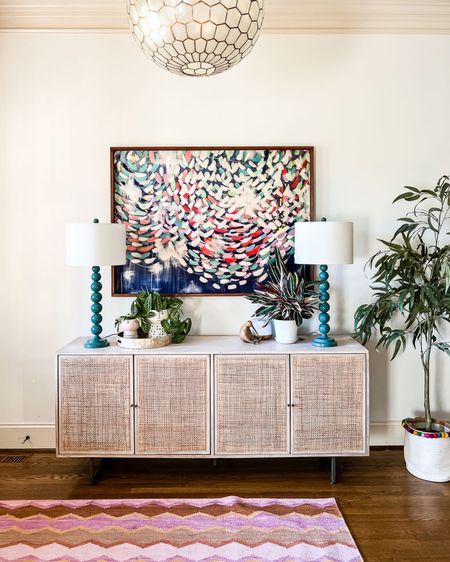 Console table, buffet, media console, sideboard, colorful artwork, colorful rug, Serena and Lily light fixture, capiz pendant light, colorful rug, Annie Selke rug, faux olive tree, Blue table lamps 

#LTKhome