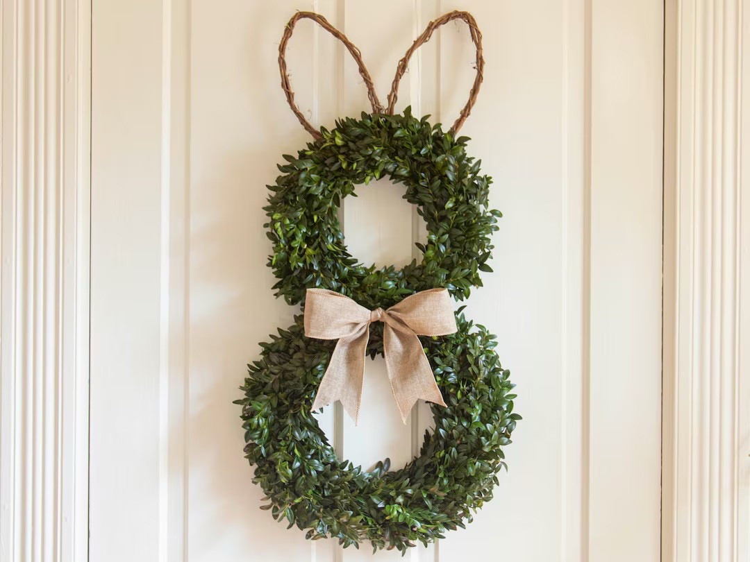 Celebrate Easter with this charming bunny wreath made from real fresh-cut boxwood and handcrafted grapevine ears, finished with a soft burlap bow for a warm farmhouse touch. Grown and harvested on a small American farm, this natural wreath brings fresh greenery and seasonal charm to your front door or entryway. As it gently dries, the boxwood transitions to a beautiful light green or golden hue, creating a timeless piece you can enjoy beyond the holiday.

#LTKHome #EasterDecor #SpringWreath #FarmhouseDecor #FrontDoorDecor #BoxwoodWreath #NaturalDecor #SpringHome #SeasonalDecor #RusticHome #AmericanGrown #SmallFarm #BunnyWreath #HomeInspiration #LTKFinds

#LTKFestival #LTKSeasonal #LTKHome