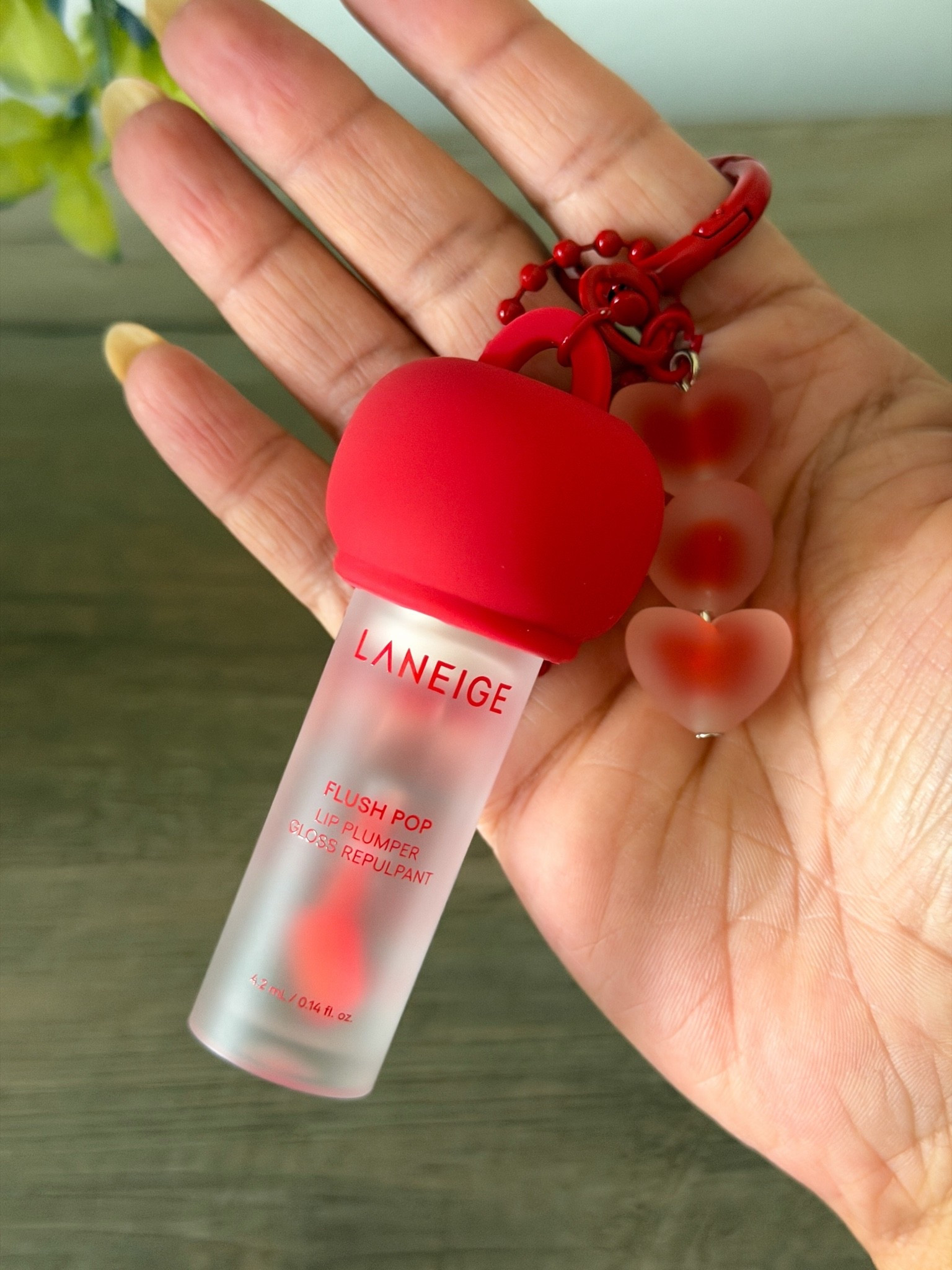 Holding the new Laneige Flush Pop Lip Plumper so you can see the bottle size and the frosted texture. I am really excited to see how this wears throughout the day for a quick everyday beauty refresh. It came with the cutest heart keychain charm as a freebie with purchase.

#LTKgrwm #LTKBeauty