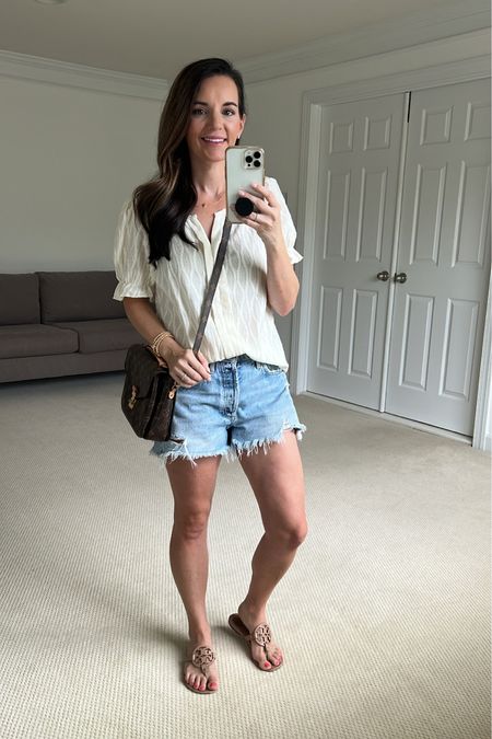 You need this top! It comes in so many colors and is light weight for summer. Wearing size s. Fit tts. 
Shorts are the agolde cutoff. BEST SHORTS EVER! I promise you will love them. 