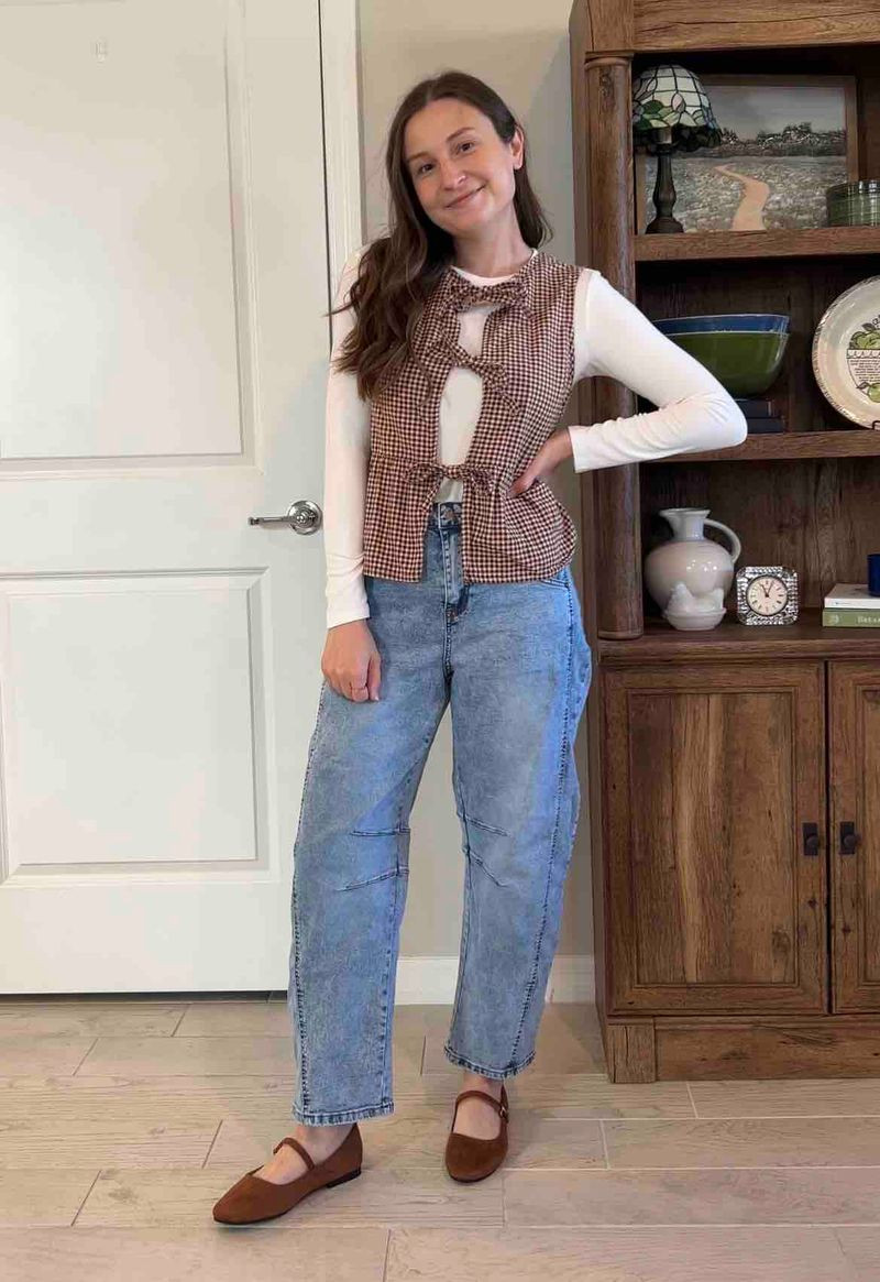 Cozy neutral fall outfit with a layered everyday mom style 🤎
Wearing a brown gingham tie-front vest over a fitted long sleeve white top, paired with high waisted barrel leg jeans and brown Mary Jane flats. This look is the perfect mix of casual, comfortable, and put-together for everyday errands, coffee runs, or staying at home with a clean girl aesthetic.

Loving this neutral color palette with warm tones, classic patterns, and effortless layering pieces. The gingham vest adds a trendy vintage-inspired touch while the denim keeps it relaxed and wearable.

#ltkstyle #ltkfall #ltkcasual #momstyle #momoutfit #everydaystyle #neutraloutfit #falloutfitideas #casualoutfit #denimstyle #straightlegjeans #layeredlook #gingham #maryjanes #effortlessstyle #cleanlook #cozystyle #minimalstyle #everydayfashion #trendyoutfits #classicstyle #outfitinspo #fallfashion #neutralstyle #simpleoutfits 

 #LTKgrwm #LTKootd #LTKmomlife