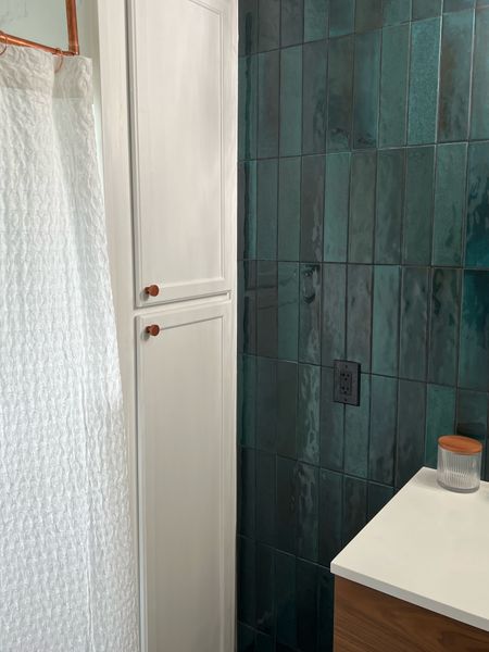Bathroom renovation, linen cabinet, teal tile and white waffle weave shower curtain 
