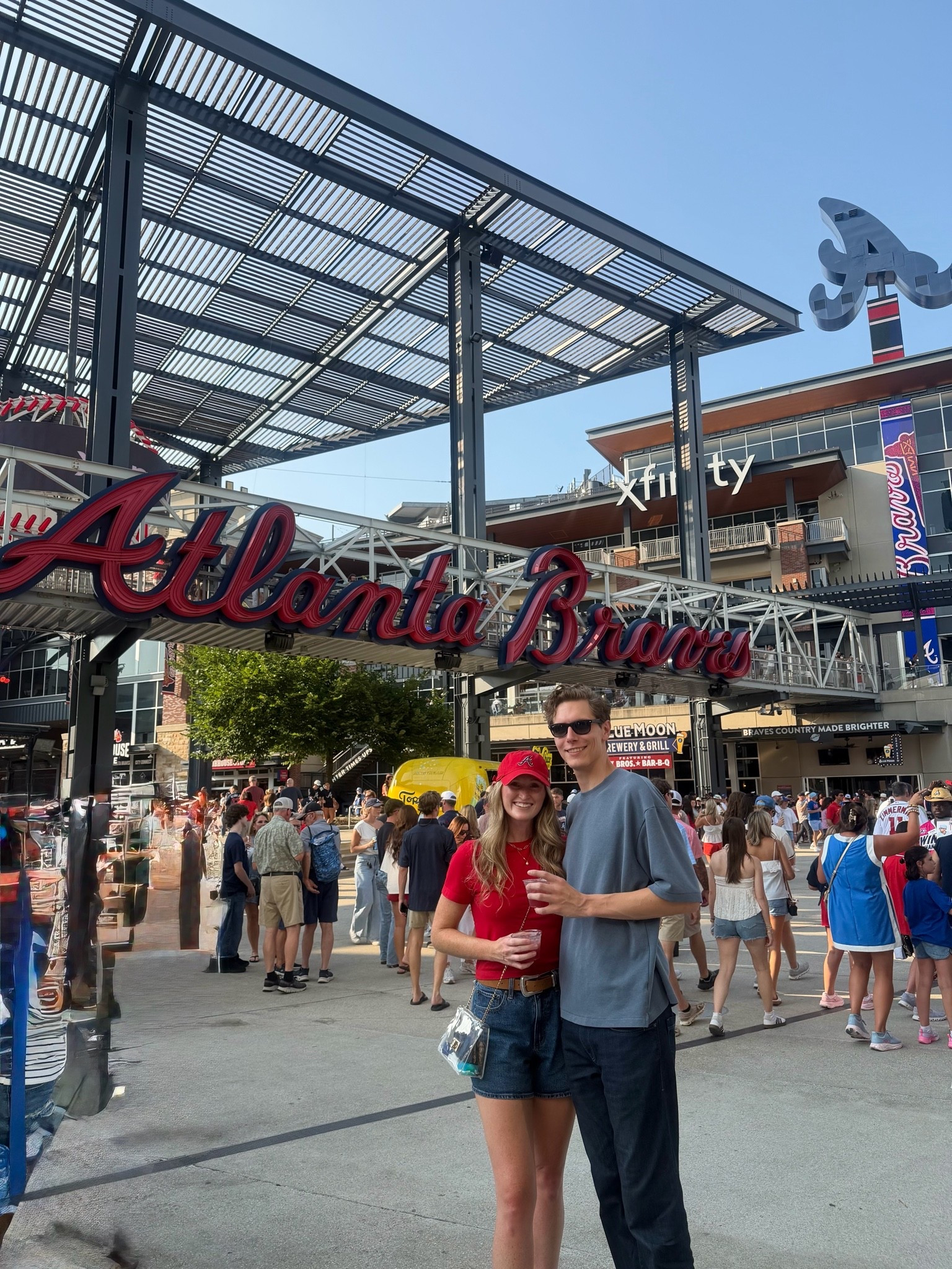 Comfortable cute date night Atlanta Braves baseball outfit. Denim shorts, active cropped top, sports team hat, clear bag

#LTKTall