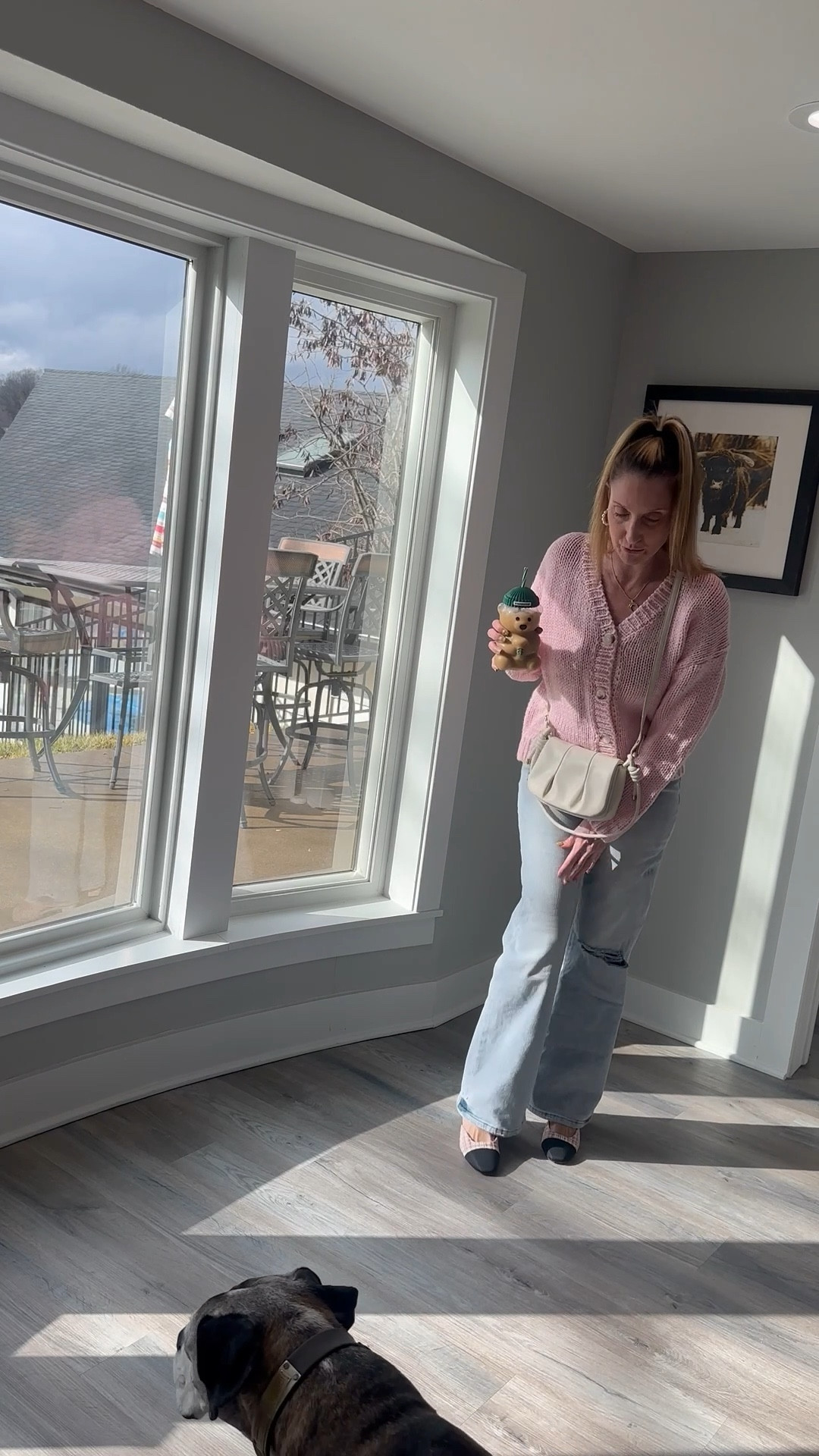 Waking up to a little bit of pink! 🌸☕️ This oversized cardigan is like a giant hug and exactly what I needed for a crisp morning at the lake. It’s the ultimate 'above-the-keyboard' piece for a busy day of WFH meetings. Shop the full look and my favorite denim on my LTK! 🛍️ #WeatherbyLakeStyle #PinkCardigan #CozyCasual

Pink oversized cardigan, chunky knit sweater, V-neck cardigan, light-wash jeans, distressed denim, cream crossbody bag, pleated handbag, bear-shaped tumbler, Weatherby Lake, WFH fashion 2026, comfy casual, transition style, spring knitwear, LTK style, feminine basics, tweed 

#LTKOver40 #LTKFindsUnder50 #LTKootd