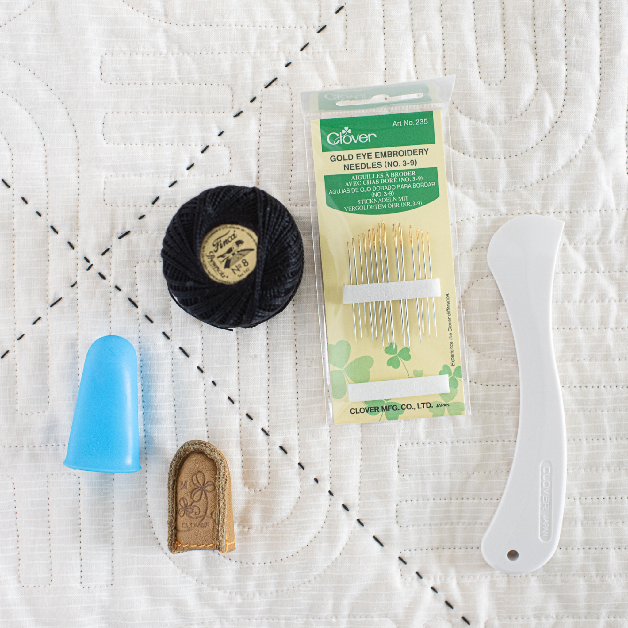 Here’s the hand quilting tools I’m liking right now:
- Perle thread - size 8
- Embroidery needles - size 3 (nice big eye for the thick thread )
- Clover comfort thimble (on my middle finger)
- Silicone thimble for my thumb 
- Hera maker for marking lines