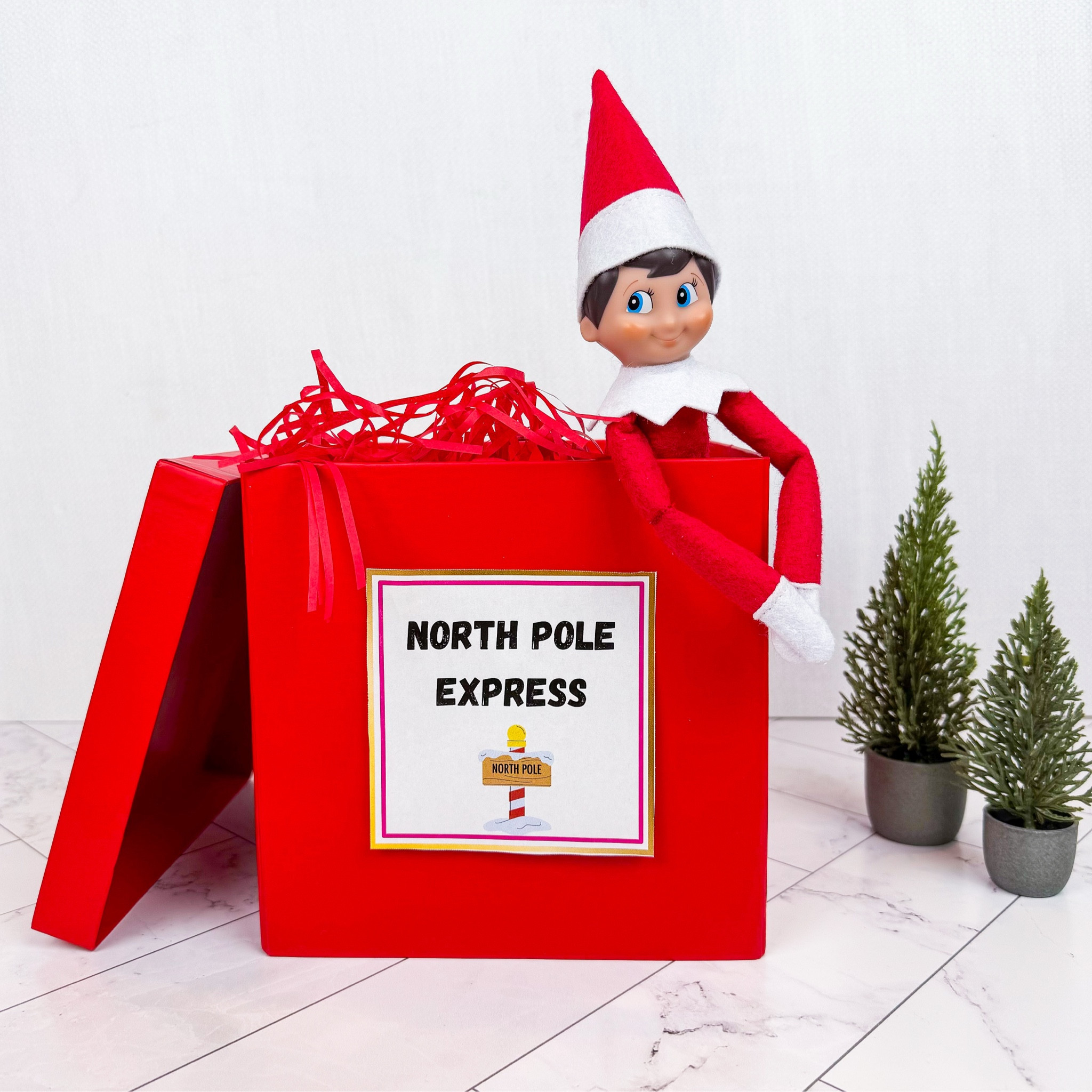 Holiday Elf arrival idea! Linked exact red box below and elf fits all the way inside with lid closed 

NOTE: Box comes with shredded red paper and lid - but sign is one of my printables that I cut out and added 

#ltkfindsunder50 #ltksalealert

#LTKHoliday #LTKHome #LTKKids