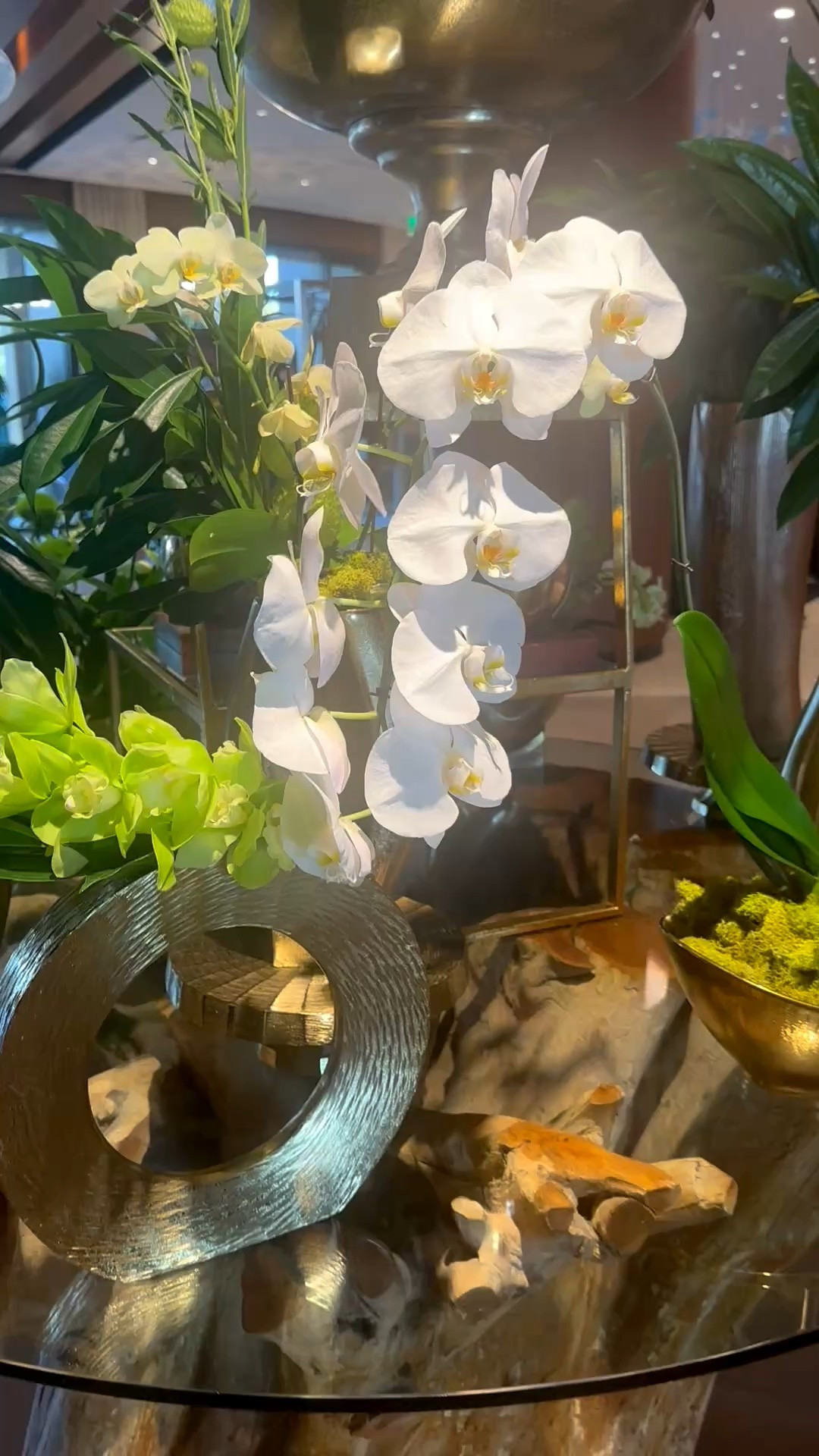 A lush orchid arrangement instantly brings a fresh, elevated feeling to summer interiors. The sculptural white and green blooms, layered greenery, moss accents, and metallic vessels create a look that feels organic yet beautifully polished—perfect for an entryway, console table, dining room, or summer entertaining space.

#FlowerArrangement #OrchidArrangement #FauxFlowers #FloralDecor #SummerDecor #EntrywayDecor #ConsoleTableDecor #DiningRoomDecor #HomeAccessories #Greenery #InteriorStyling #ModernClassicHome

#LTKdayinmylife #LTKHome